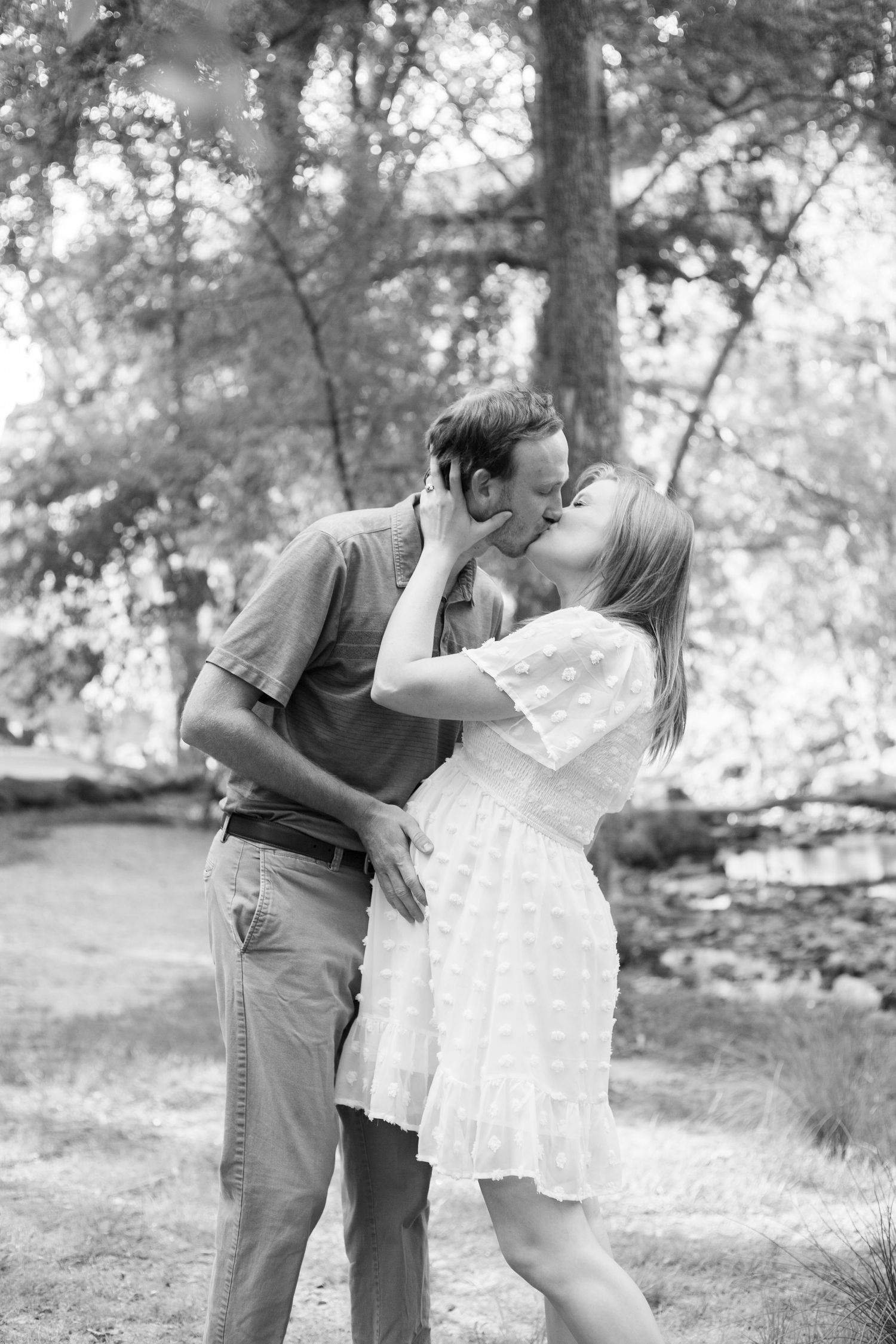 Couple photography in Greenville SC kissing and holding each other close during the day. Black and white photography
