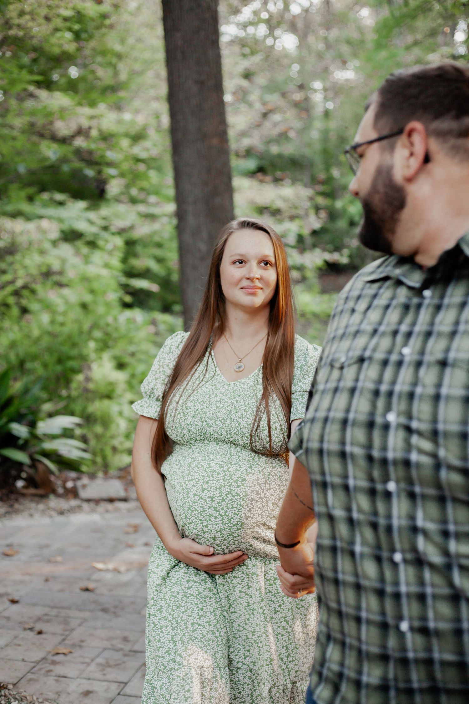 young couple holding hands photo shoot in wooded forest in south carolina spartanburg