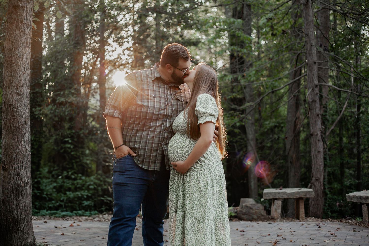 young couple photo shoot kissing in wooded forest in south carolina spartanburg