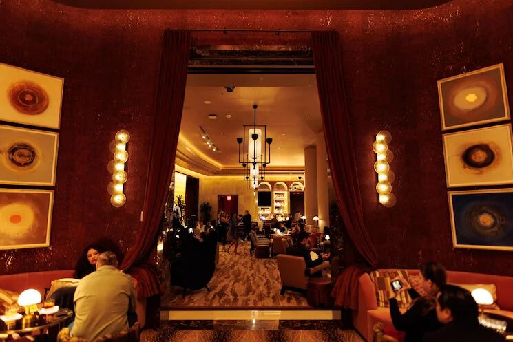 Warm-toned interior of a restaurant with vintage record albums decorating the walls.
