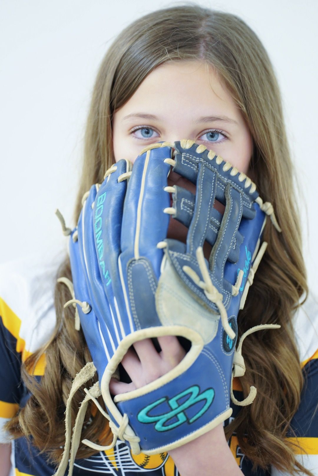A series of four photos showing someone playfully hiding their face behind a blue baseball glove.