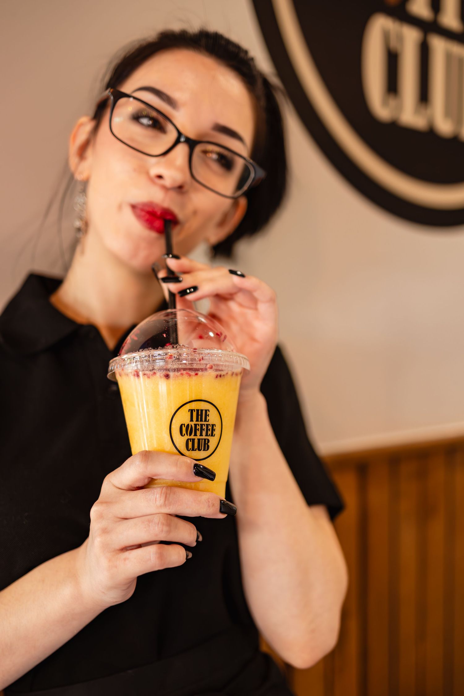 Lifestyle content photography of a female drinking an iced fruit beverage at a cafe in Ramsgate Kent.