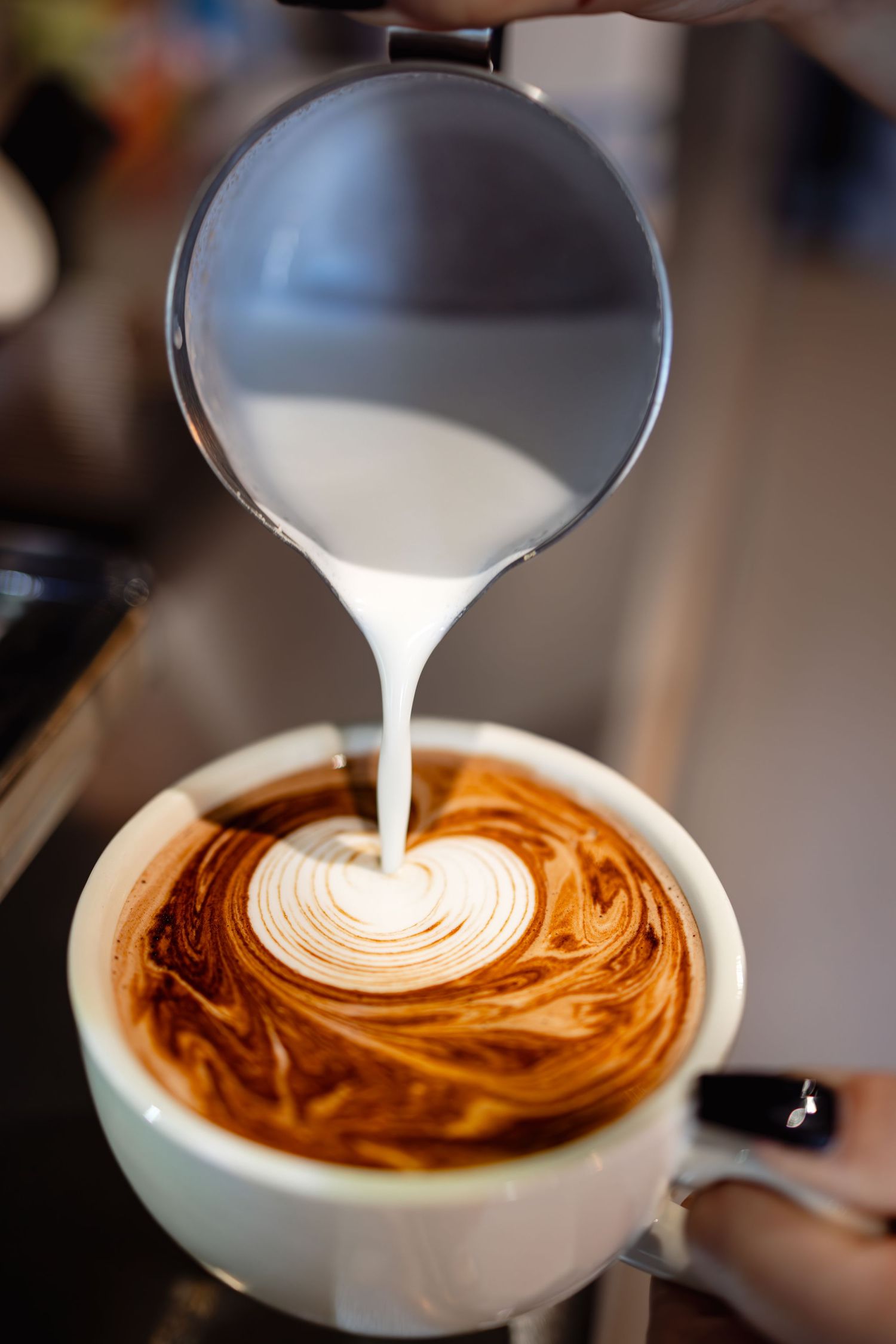 Lifestyle content photography of a barista pouring a coffee at a cafe in Ramsgate Kent.