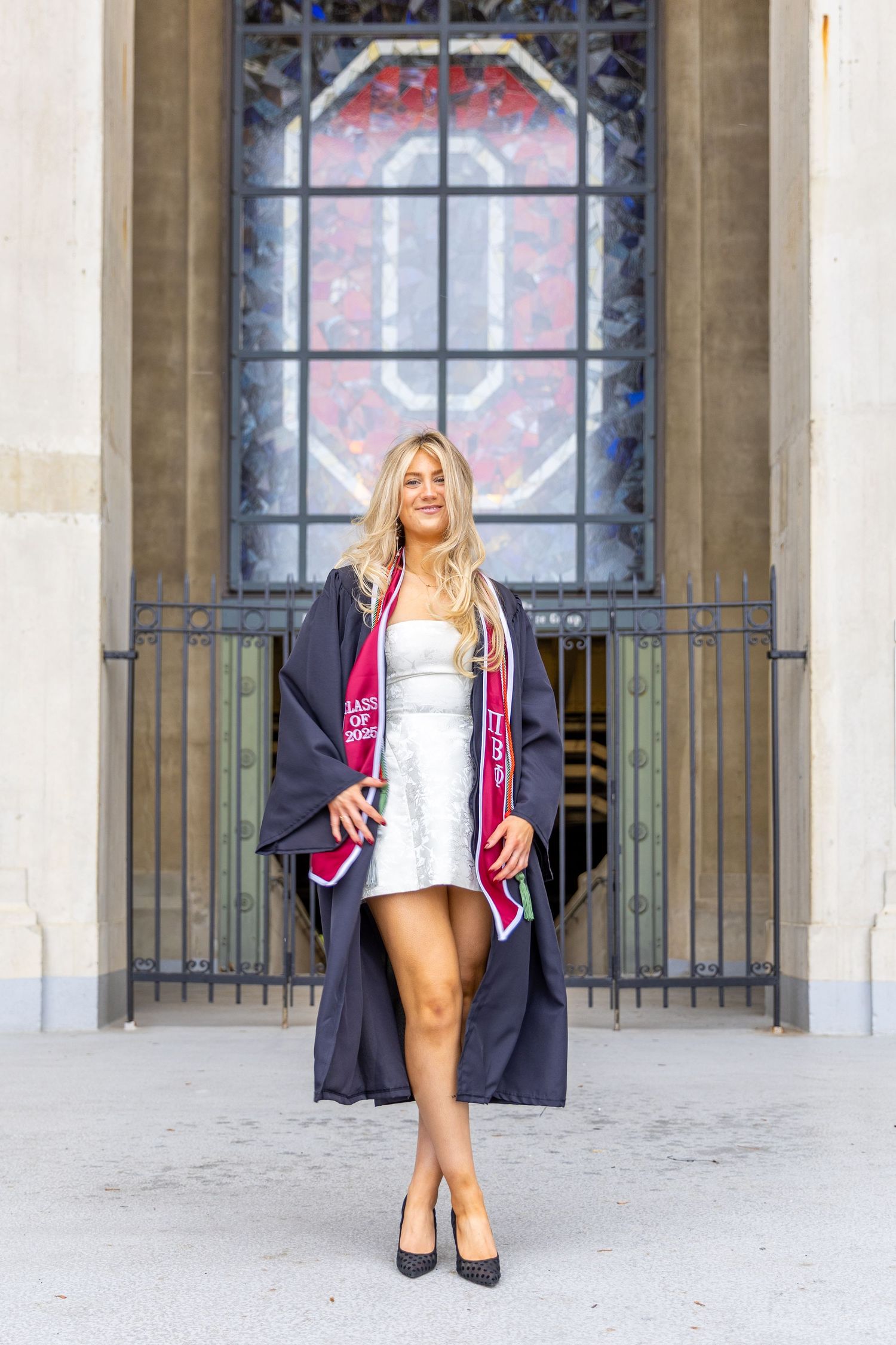 Three fashion poses in front of stone archways featuring a silver dress and pink varsity jacket styled outfit.