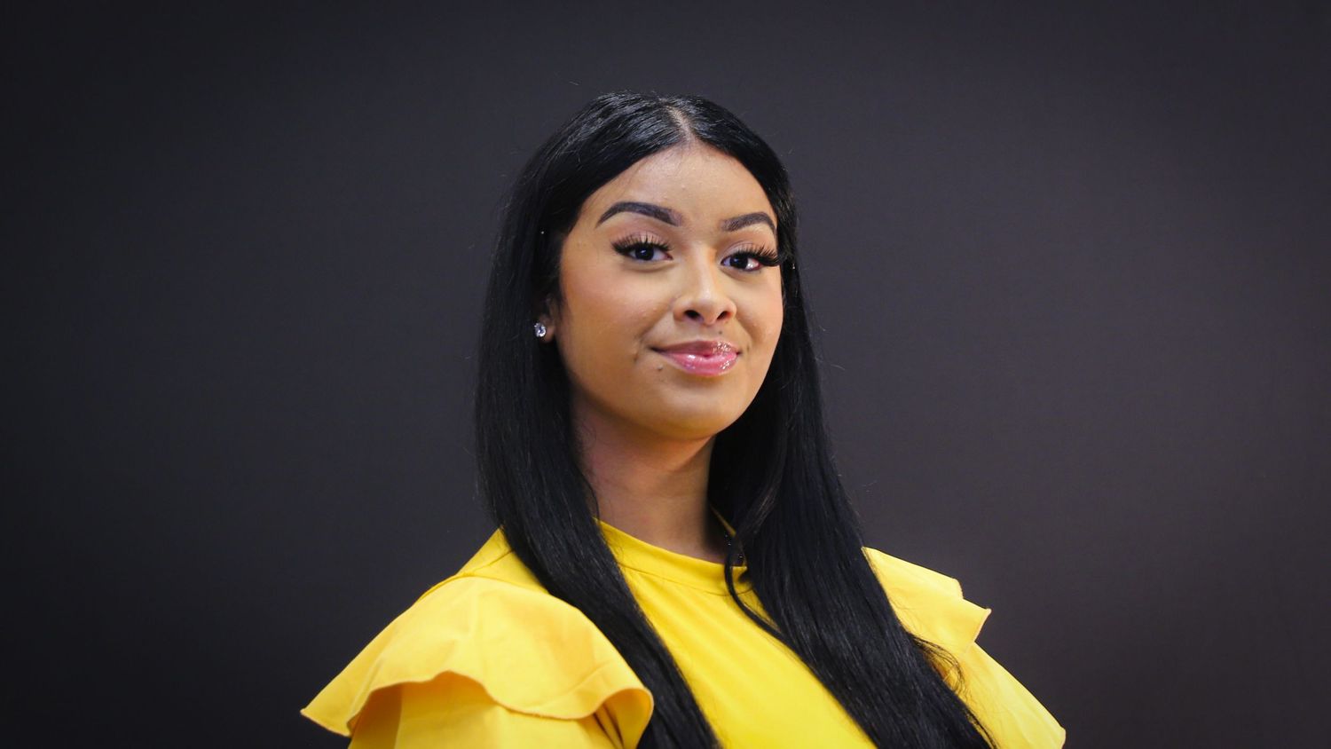 Series of portraits showing person in yellow blazer with dark hair against black background.