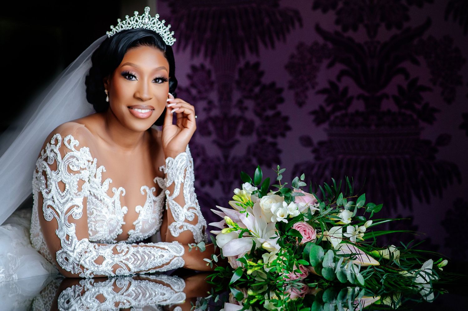 Bridal portraits with lace dress details and floral bouquet against purple background.