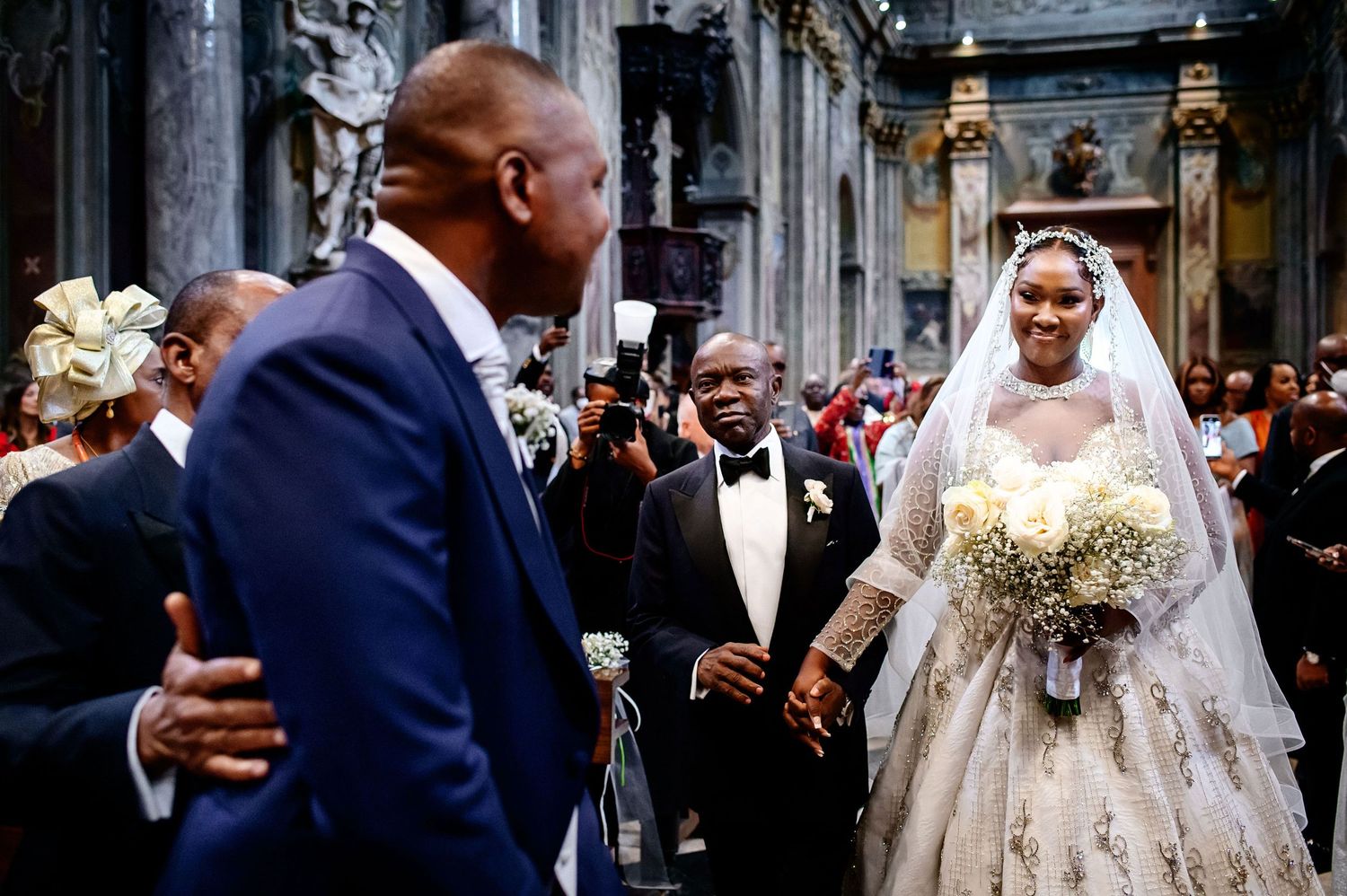 Wedding celebration in ornate church with guests and decorative details.