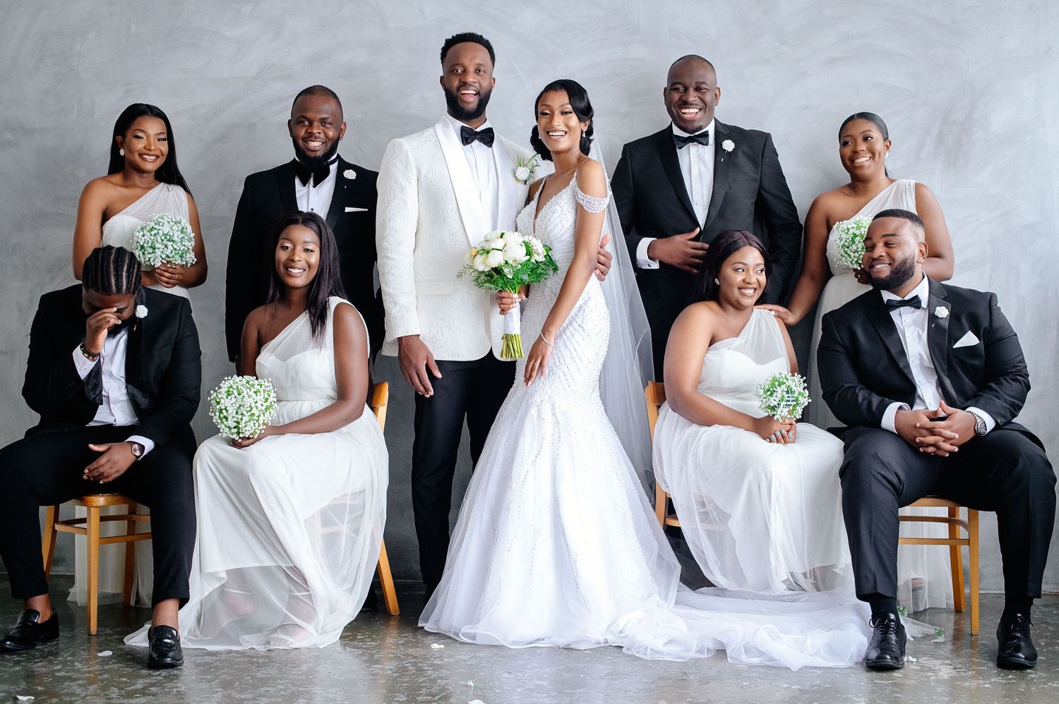 Wedding party in formal attire poses together in a series of candid group photos.