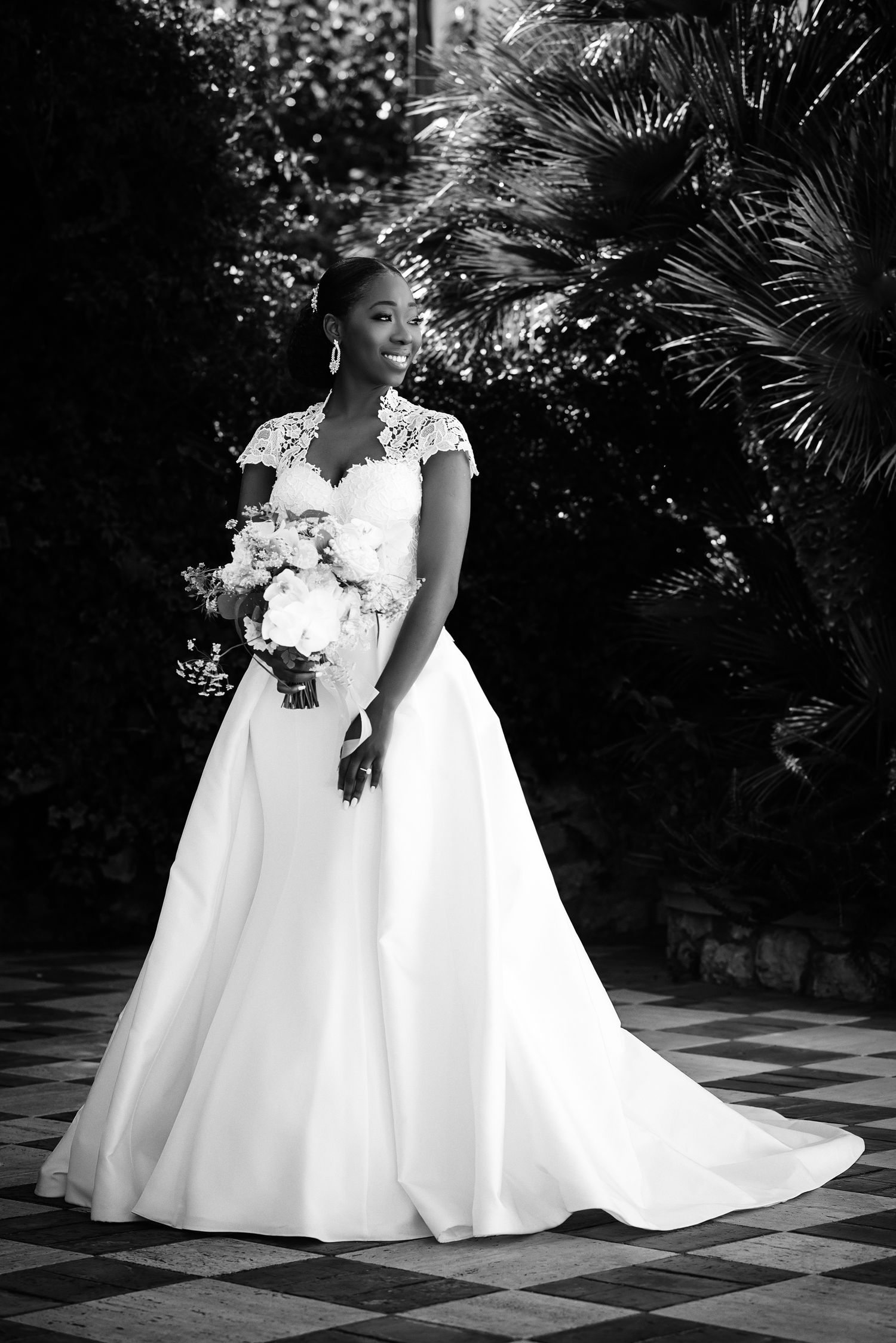 Series of black and white photos showing flowing wedding dresses on a checkered outdoor patio.