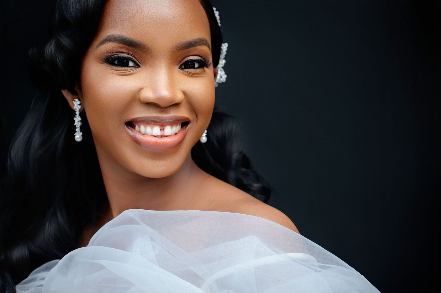 Close-up portraits against dark background showcase elegant bridal makeup and jewelry.