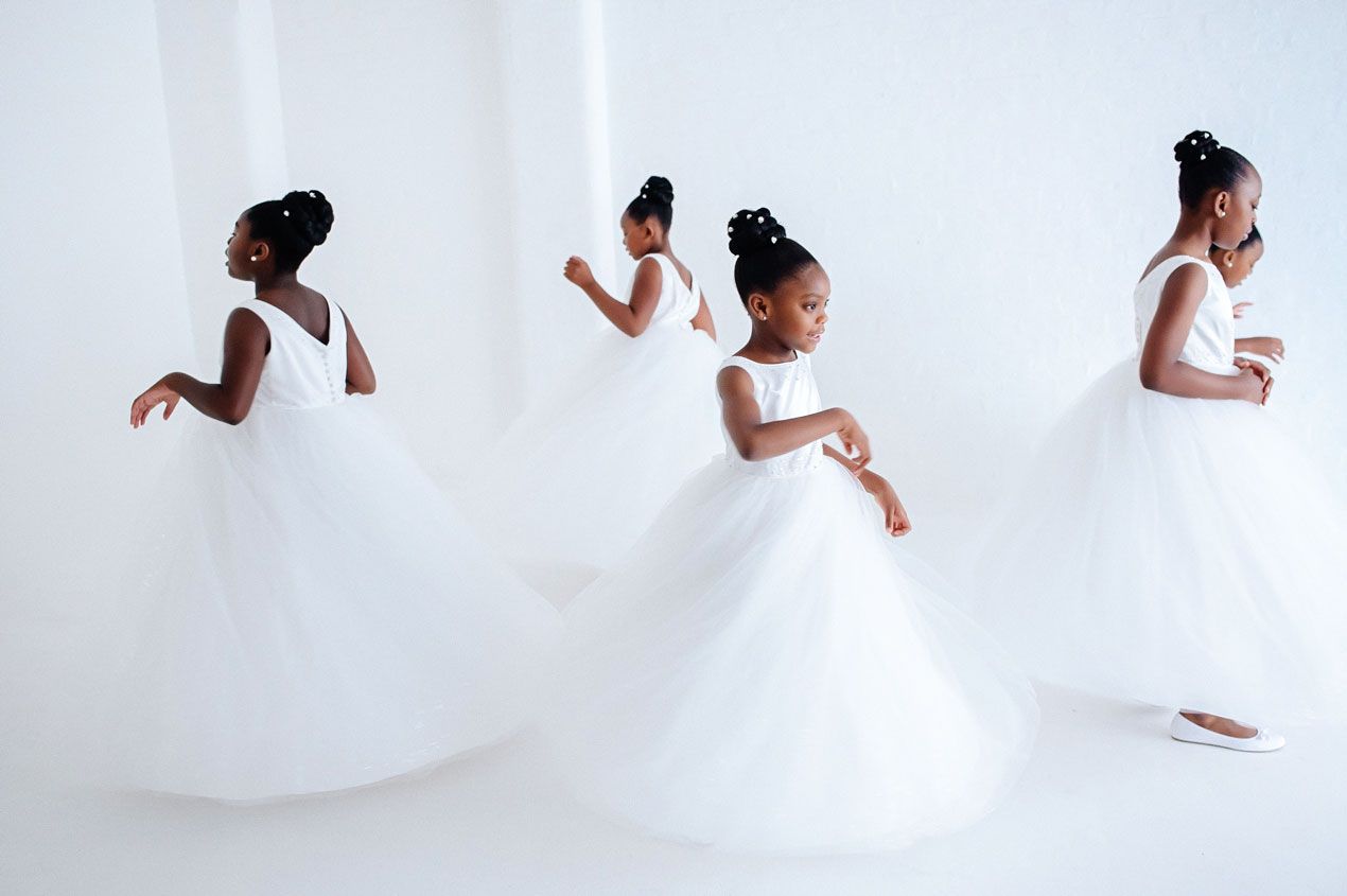 Dance sequence in white showing graceful movement against bright background.