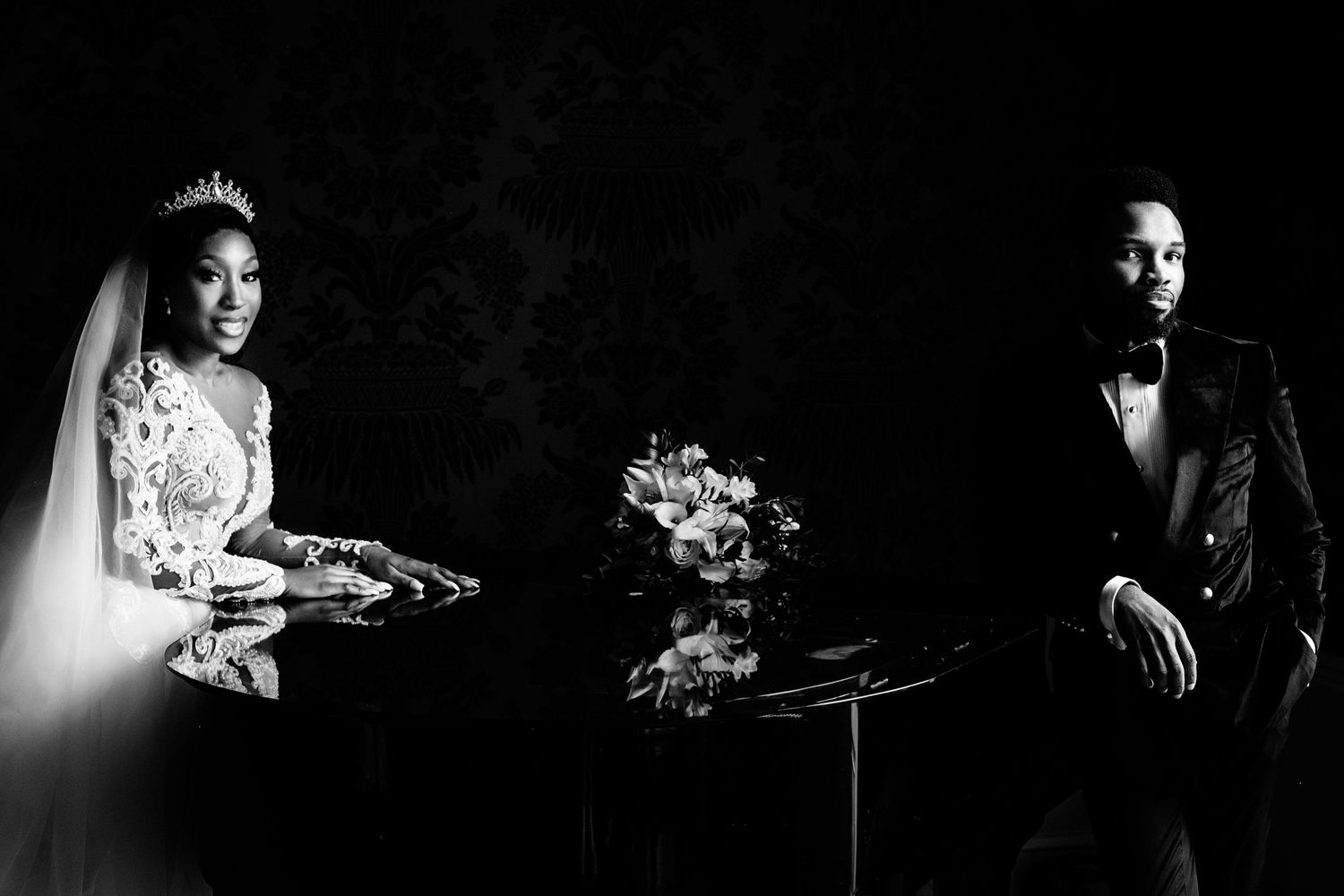 Dramatic black and white wedding photography with artistic lighting.