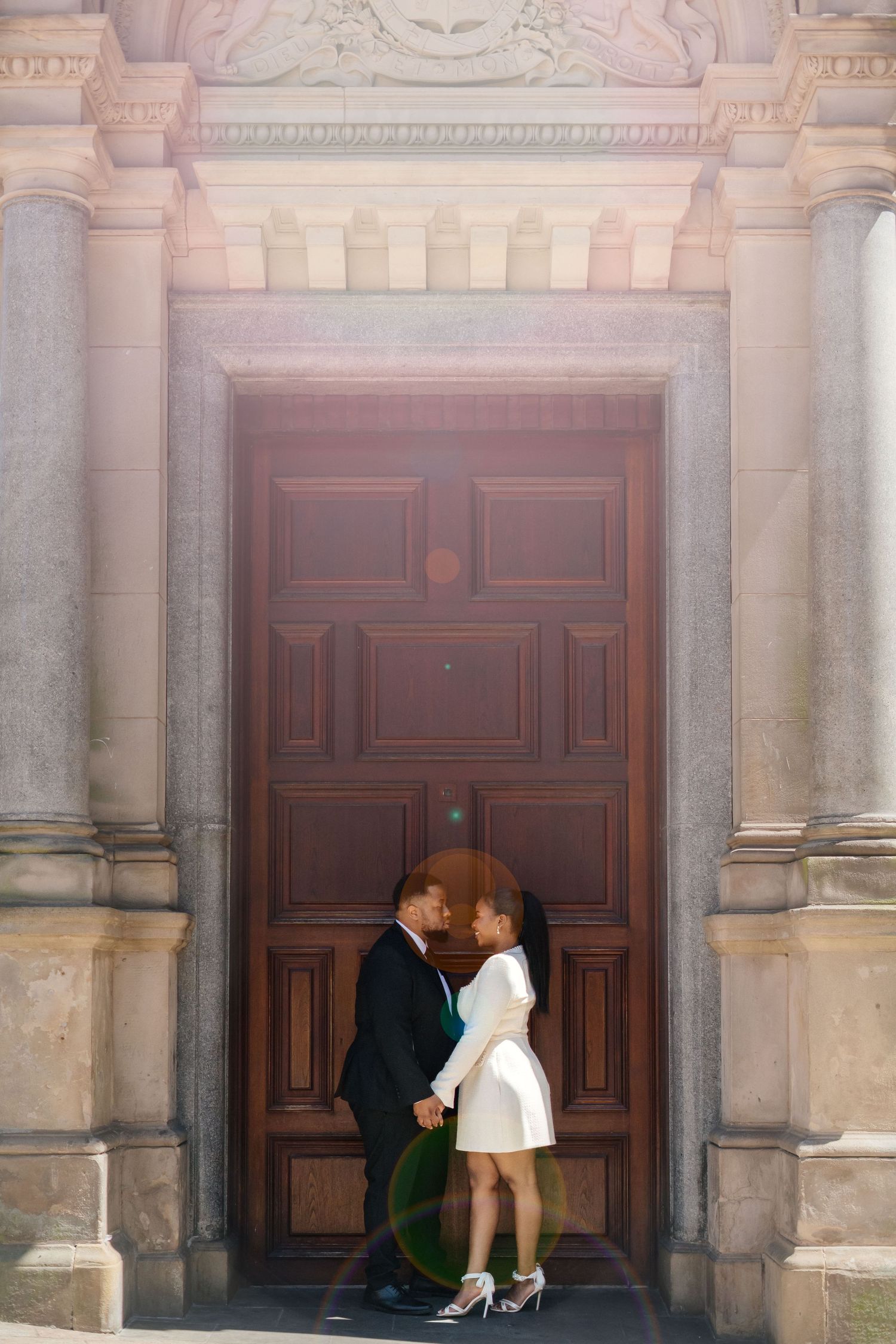 Artistic wedding photo sequence showing couple posing against ornate stone architecture.