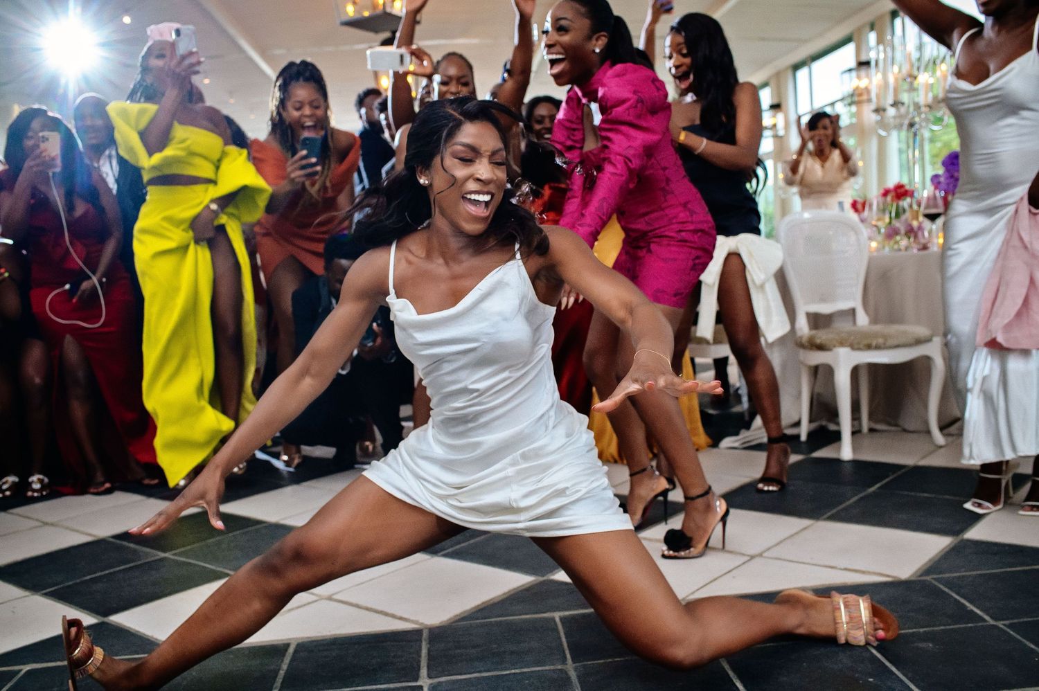 Wedding reception dance party with guests showing off impressive dance moves.