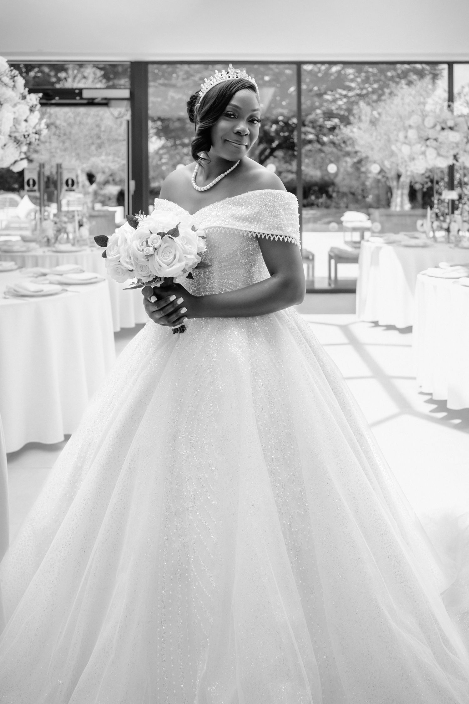 Black and white photos of a flowing white wedding dress with tulle skirt.