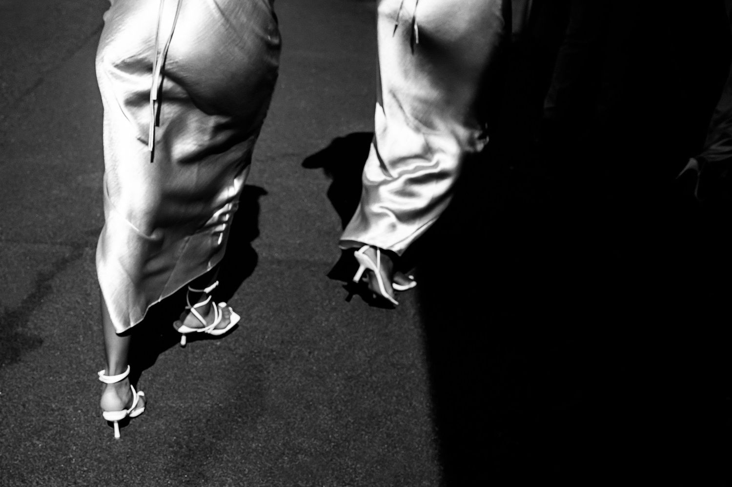 Black and white detail shot of wedding dress and shoes.