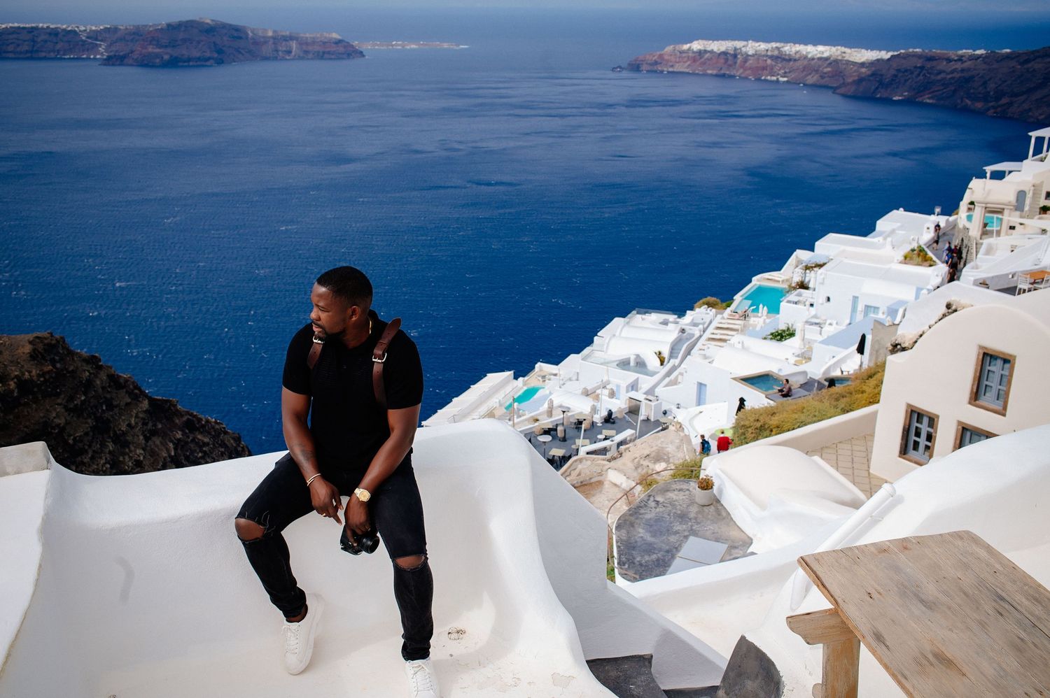 Scenic views of white buildings along Mediterranean coastline in Santorini.