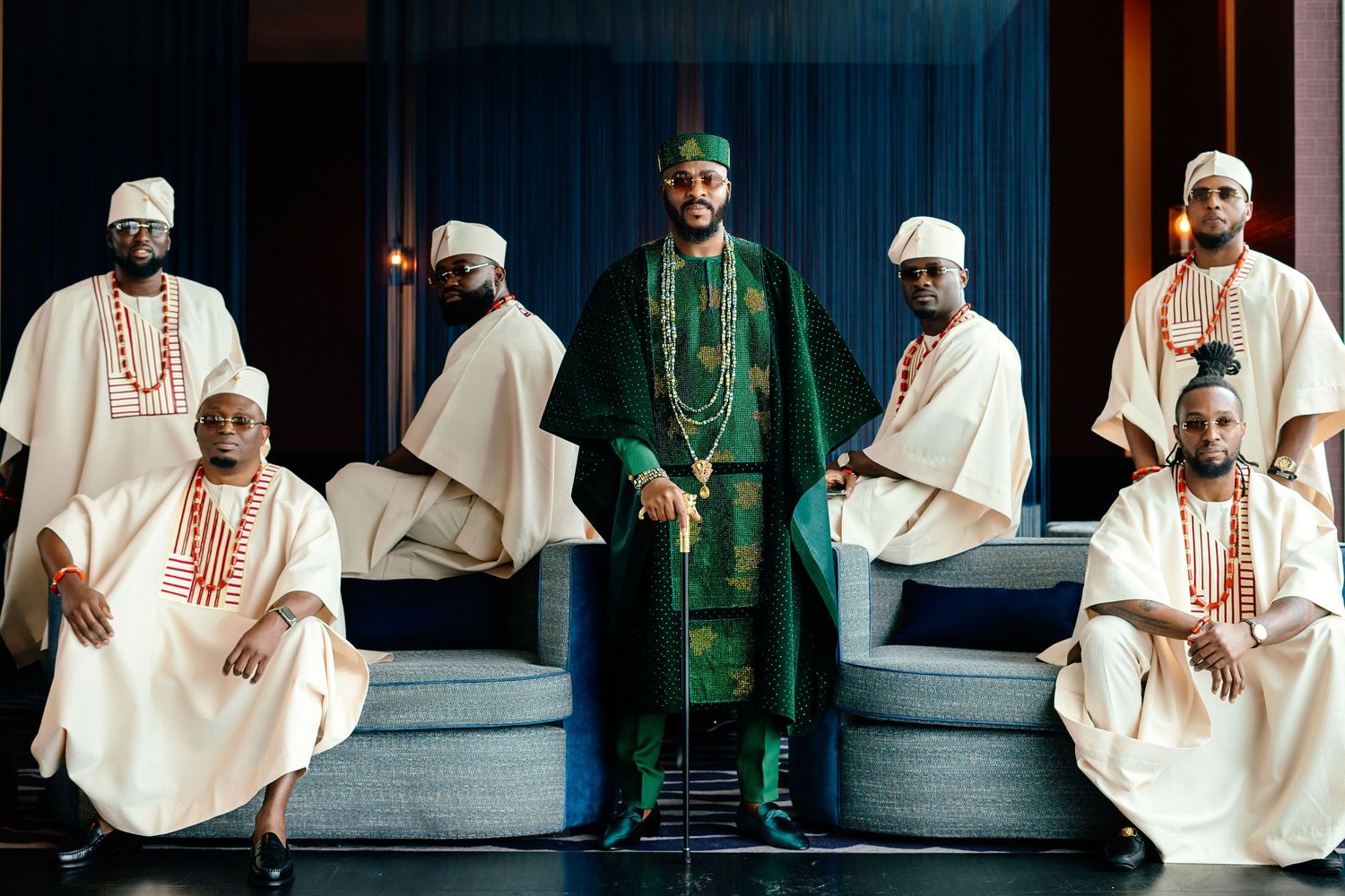 Men wearing traditional Nigerian agbada outfits in white and green colors.