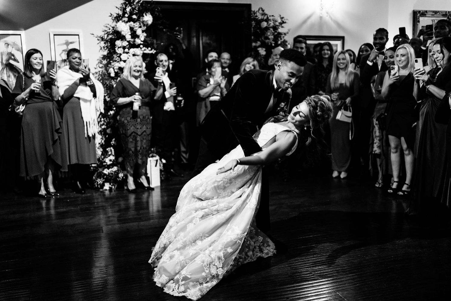 Wedding reception dance floor moments captured in dramatic black and white photography.