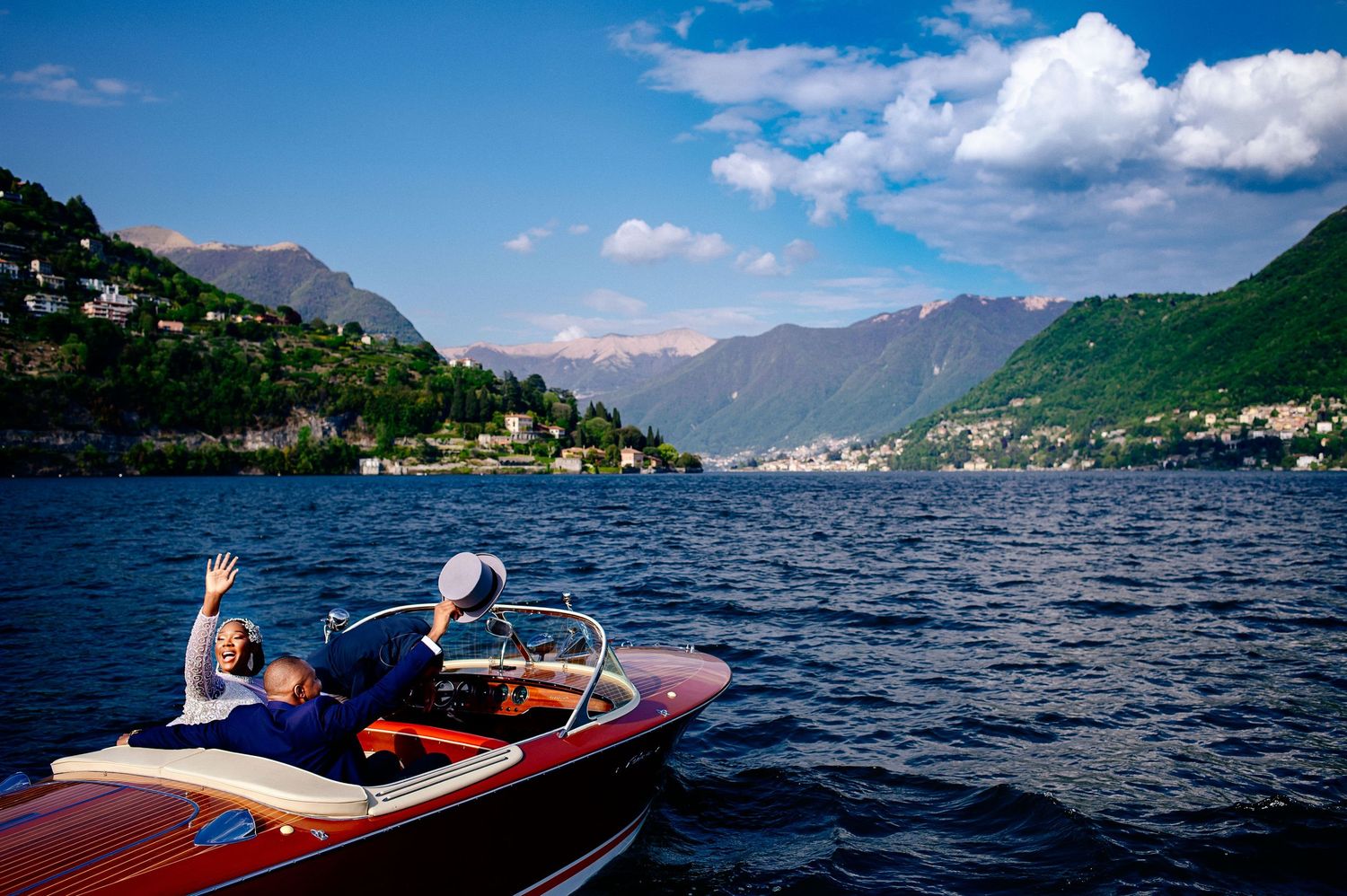 Panoramic views of a lake surrounded by mountains on a sunny day.