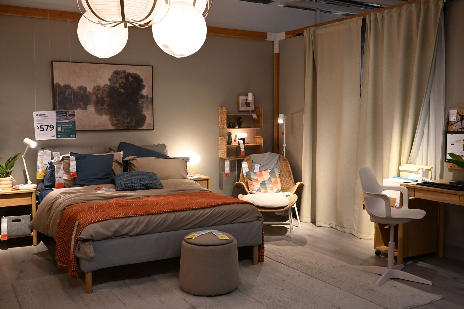 A cozy modern bedroom interior featuring a made bed, spherical pendant lights, and soft neutral decor.