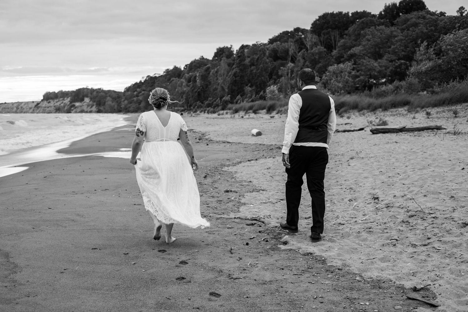 A wedding couple snuck off after the ceremony to get some private wedding photos at Port Stanley beach, Ontario.