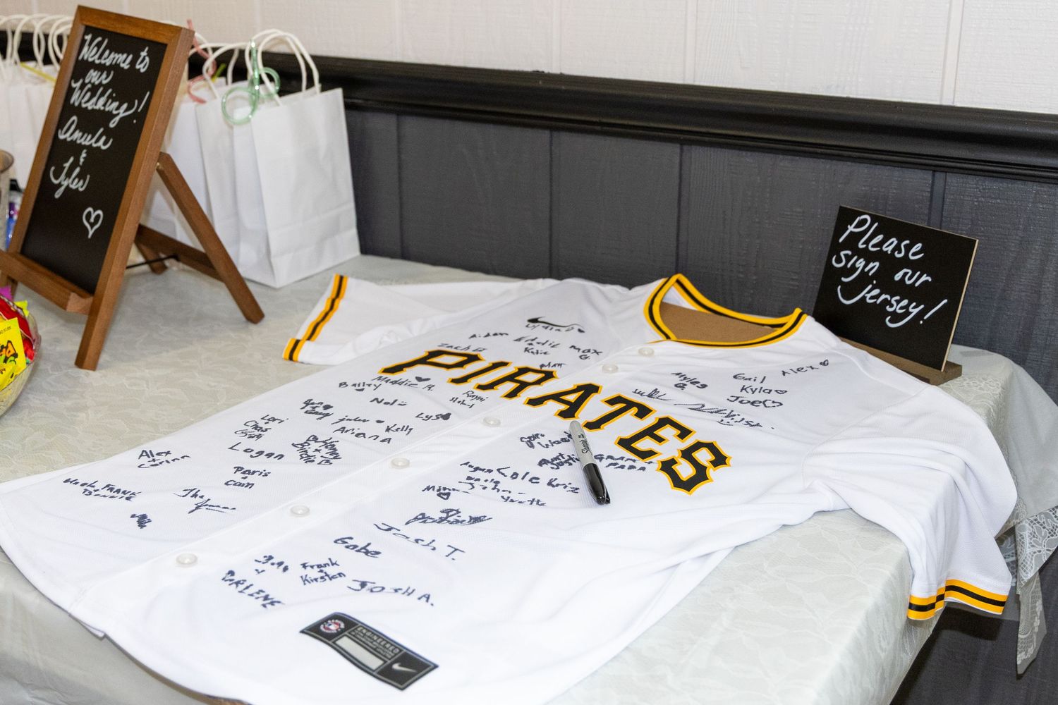 Pittsburgh Pirates white jersey used as a guest book with signatures at a wedding reception event.