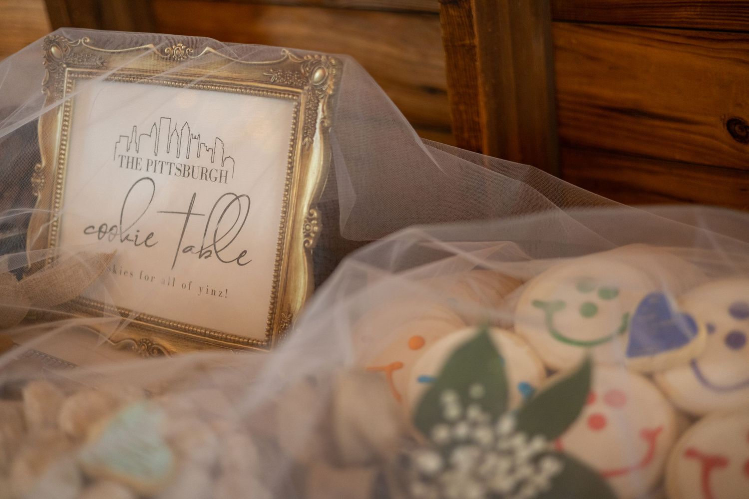 Pittsburgh cookie table wedding tradition display with assorted decorated cookies under a bridal veil.