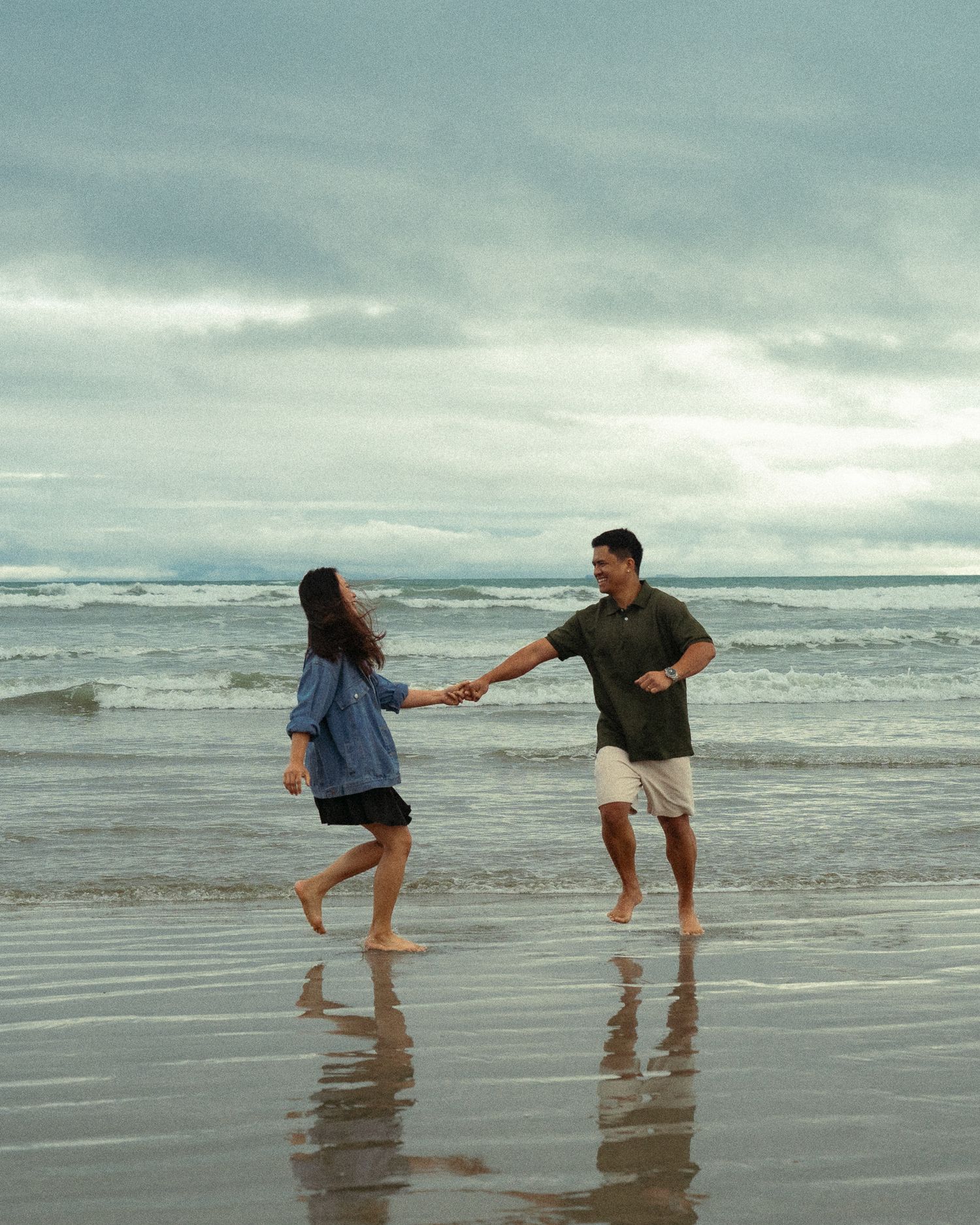 Couple holding hands on the beach