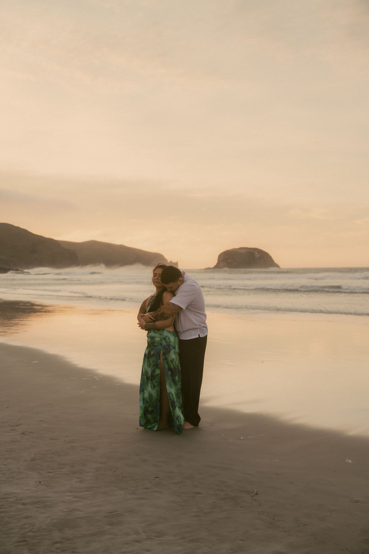 Couple embracing each other on the beach.