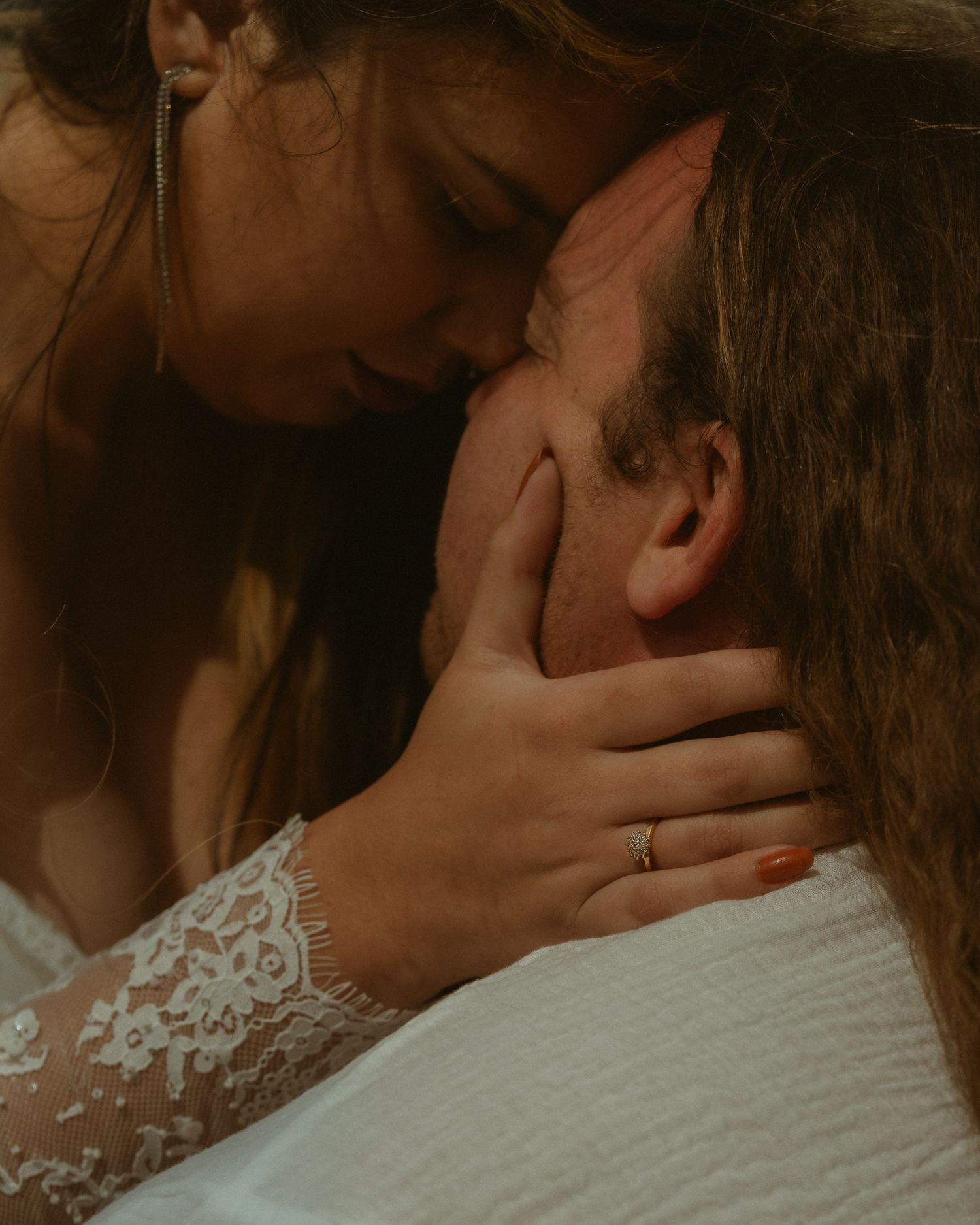 Close up of couple embracing on wedding day