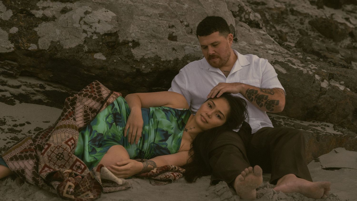 Close up of couple on rocks at the beach in embrace
