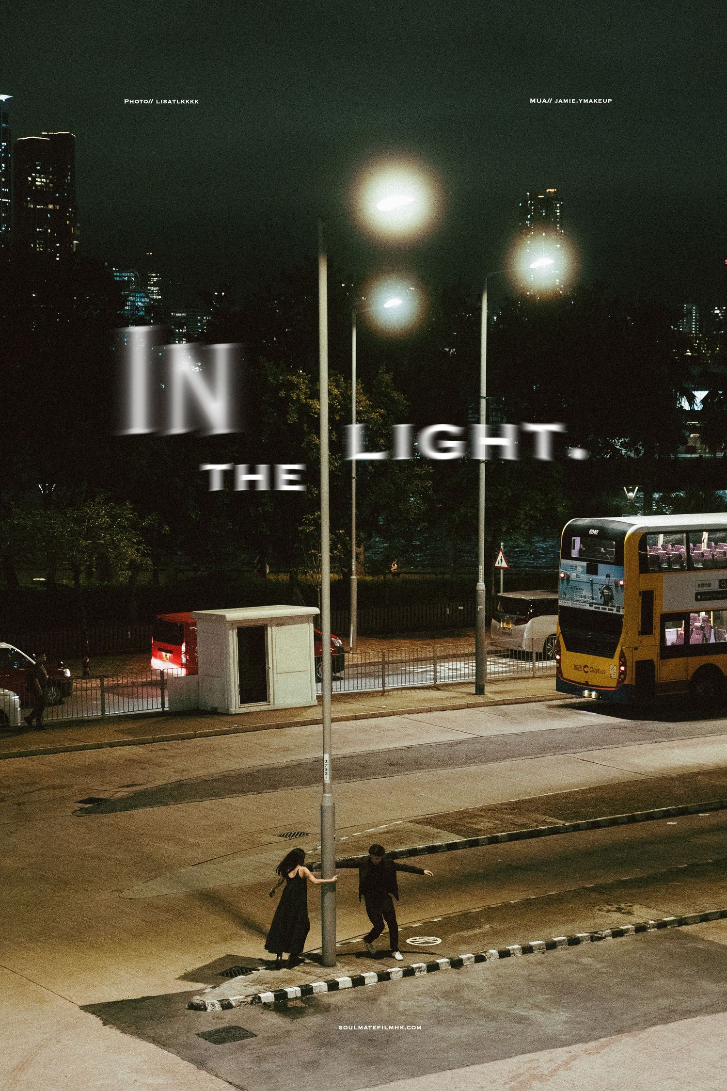 Couple embracing by a lamppost at night with text overlay reading In The Light.