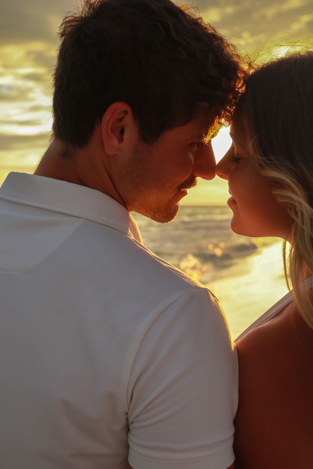 Couple sharing a close moment at sunset on a Florida beach