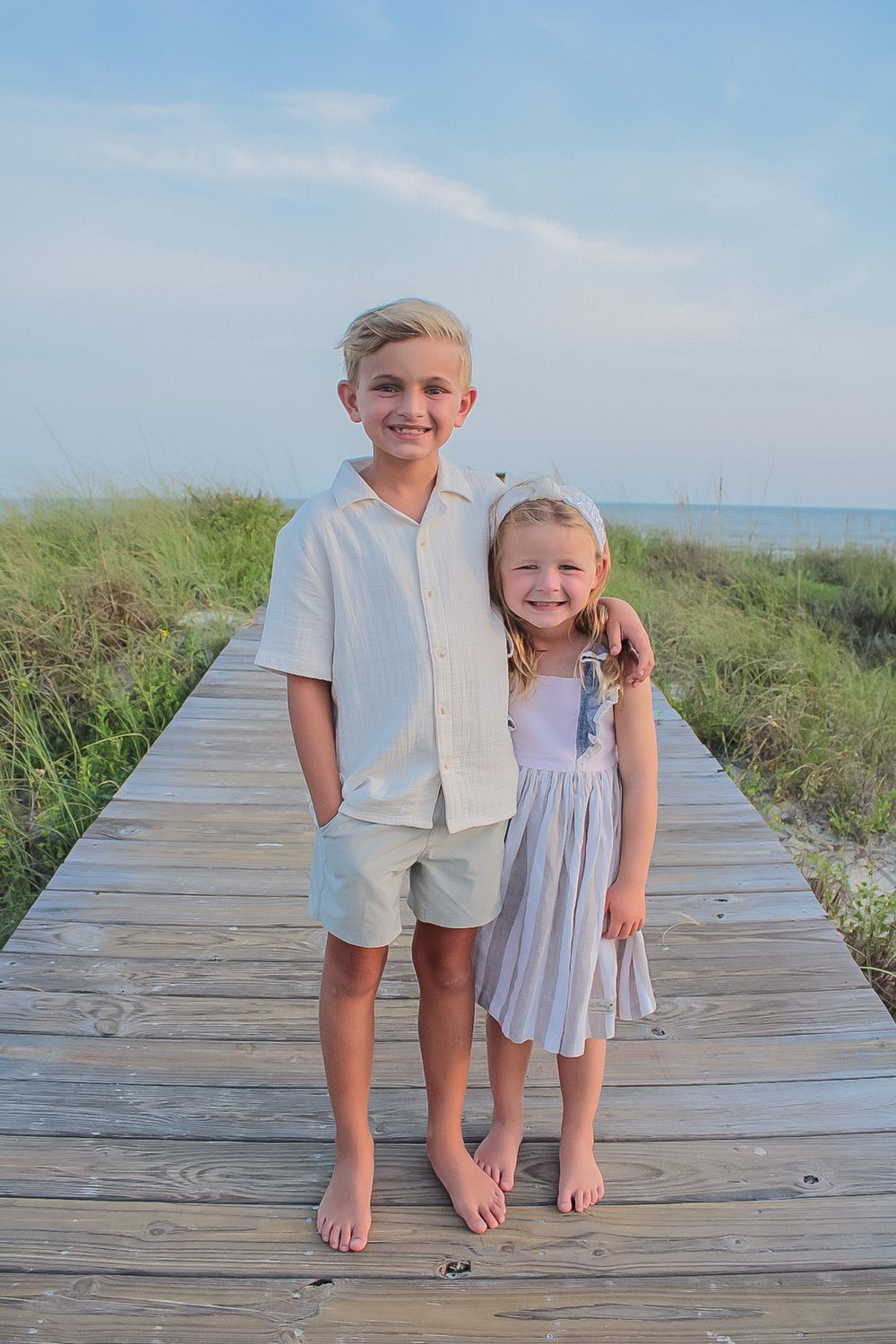 Brother and sister standing on a beach boardwalk on Florida's Gulf Coast