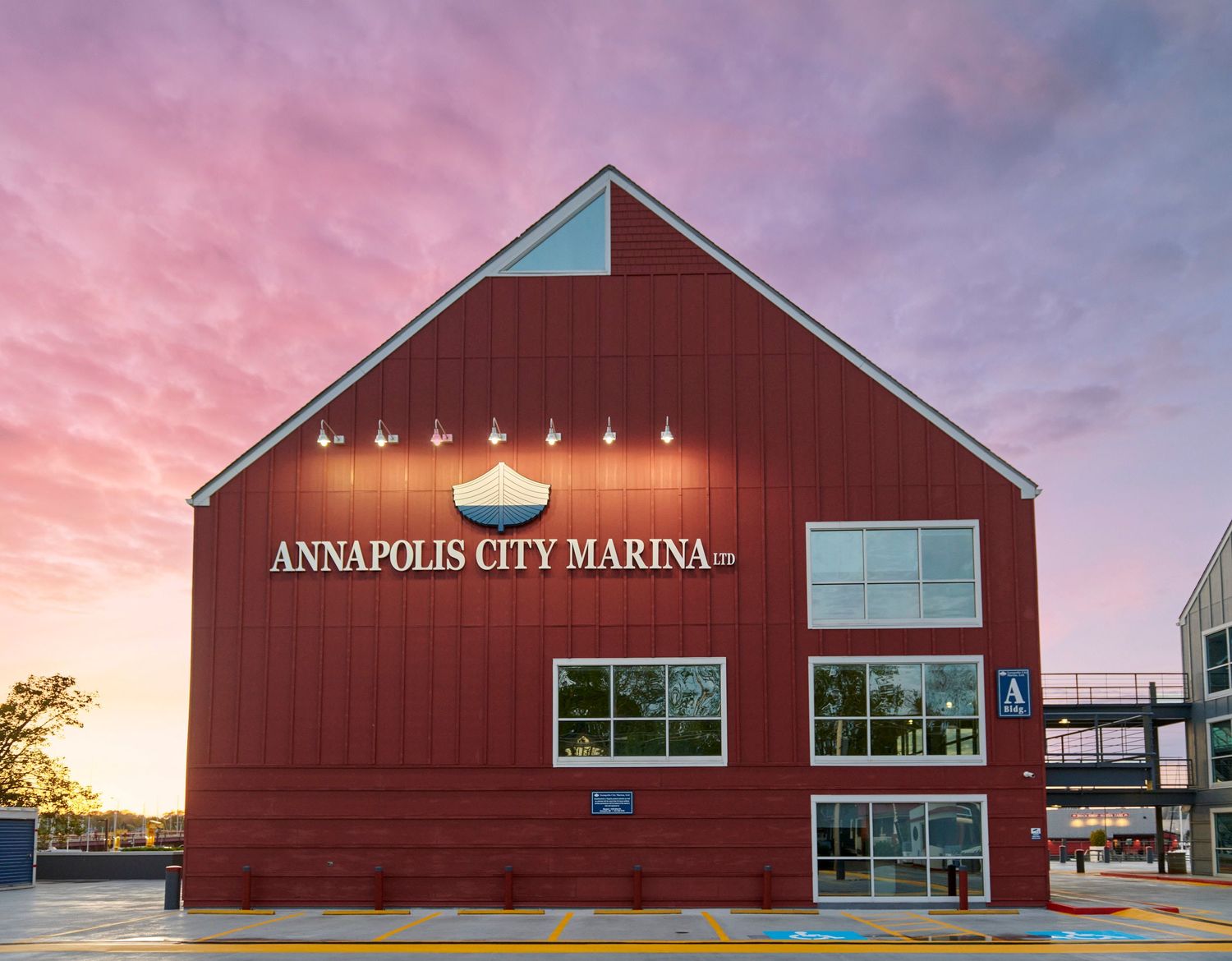 Annapolis City Marina building at sunset with vibrant pink and purple sky in Maryland.