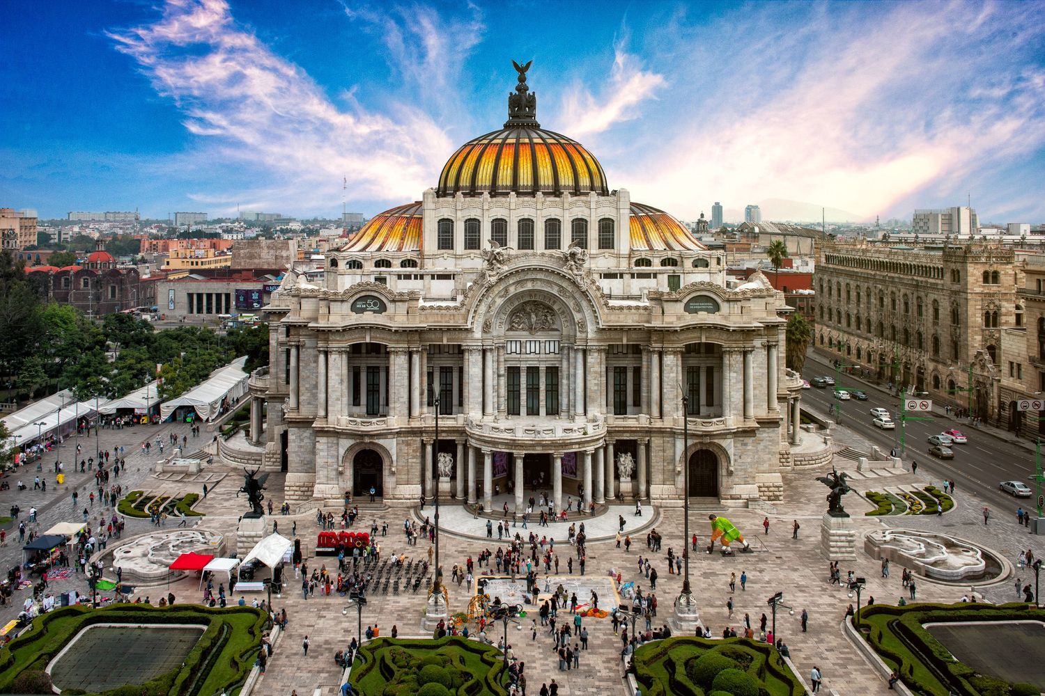 Aerial view of the ornate Palacio de Bellas Artes with golden dome in Mexico City.