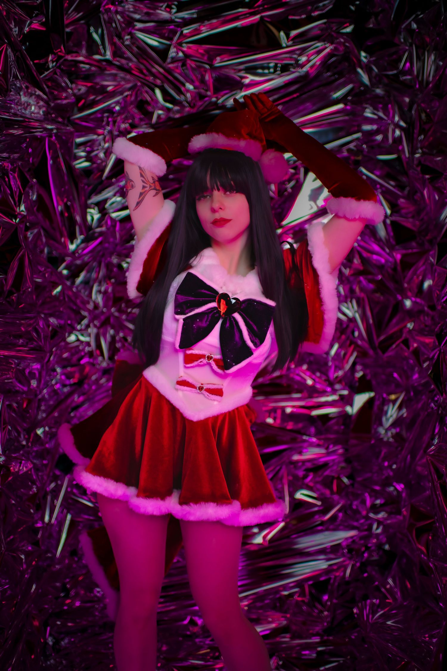 Figure in a red and white outfit poses against a glittery purple background with dramatic lighting effects.