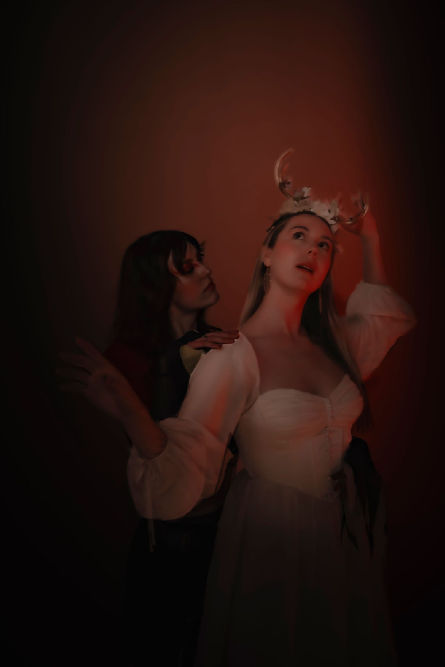 A dramatic dark portrait sequence showing a figure in white against a shadowy red background.