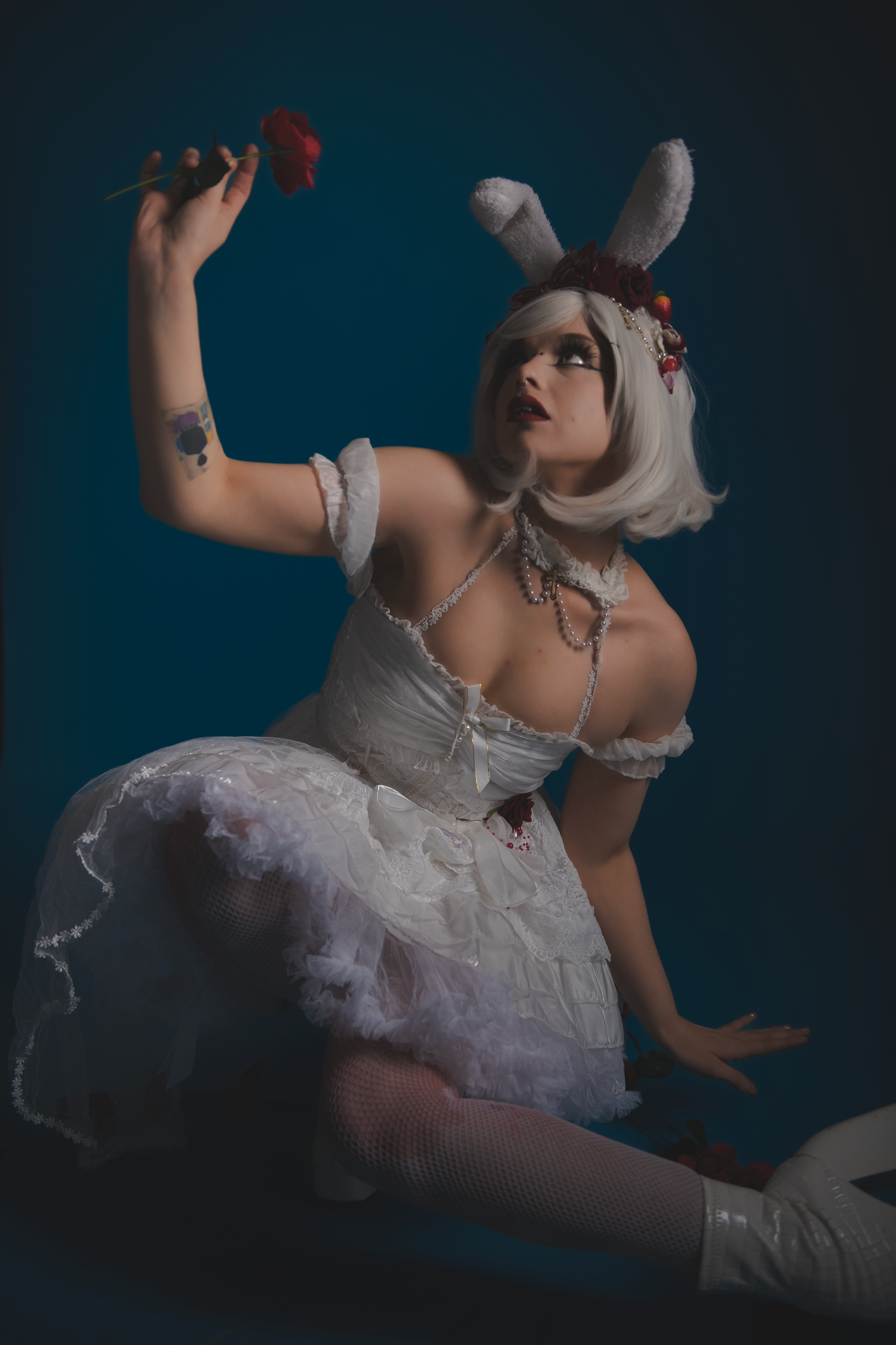 A dramatic artistic photo series showing flowing white dress movements against a dark blue background.
