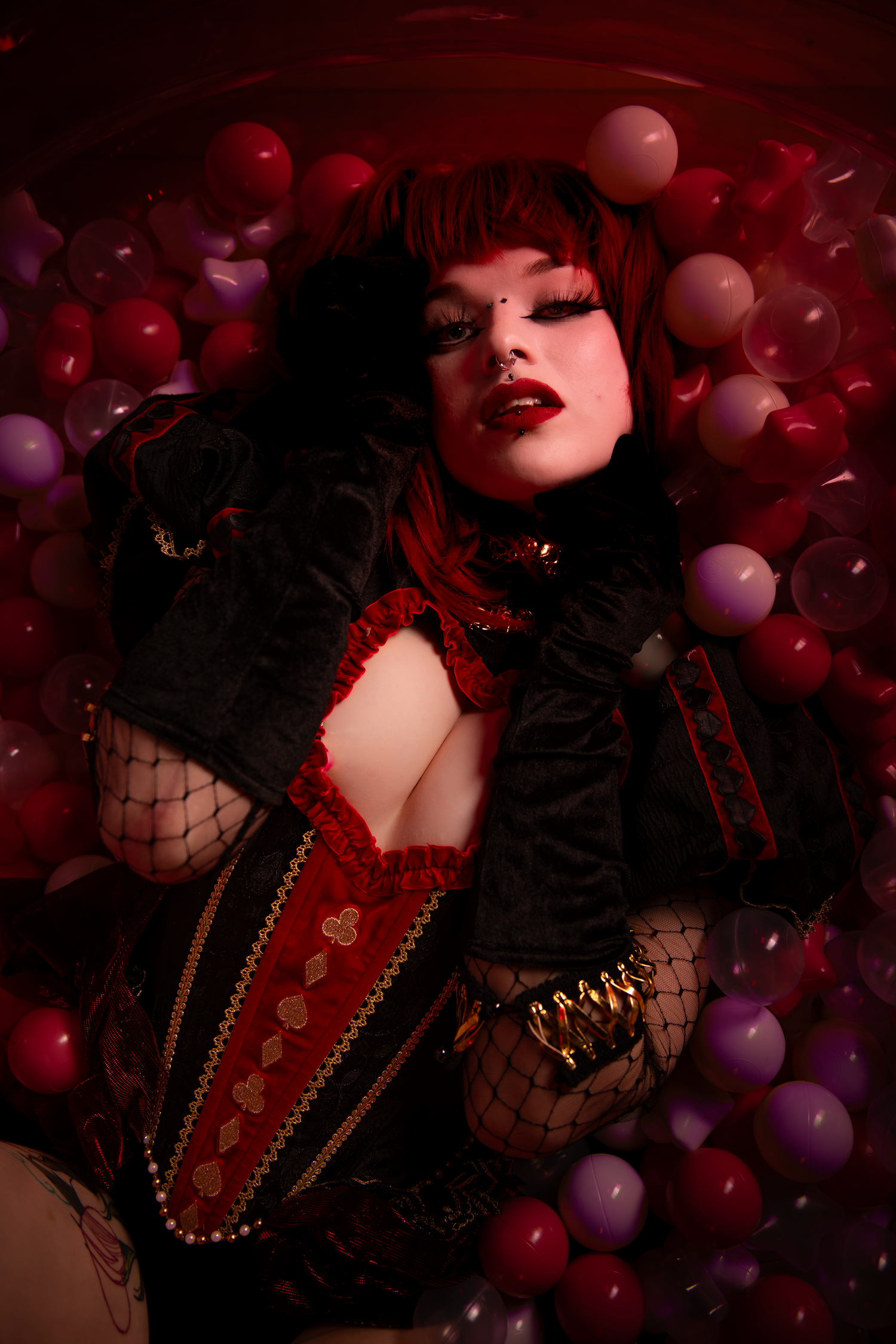 Atmospheric photo series in dark red tones featuring balloons, black lace, and pearls in a gothic romantic style.