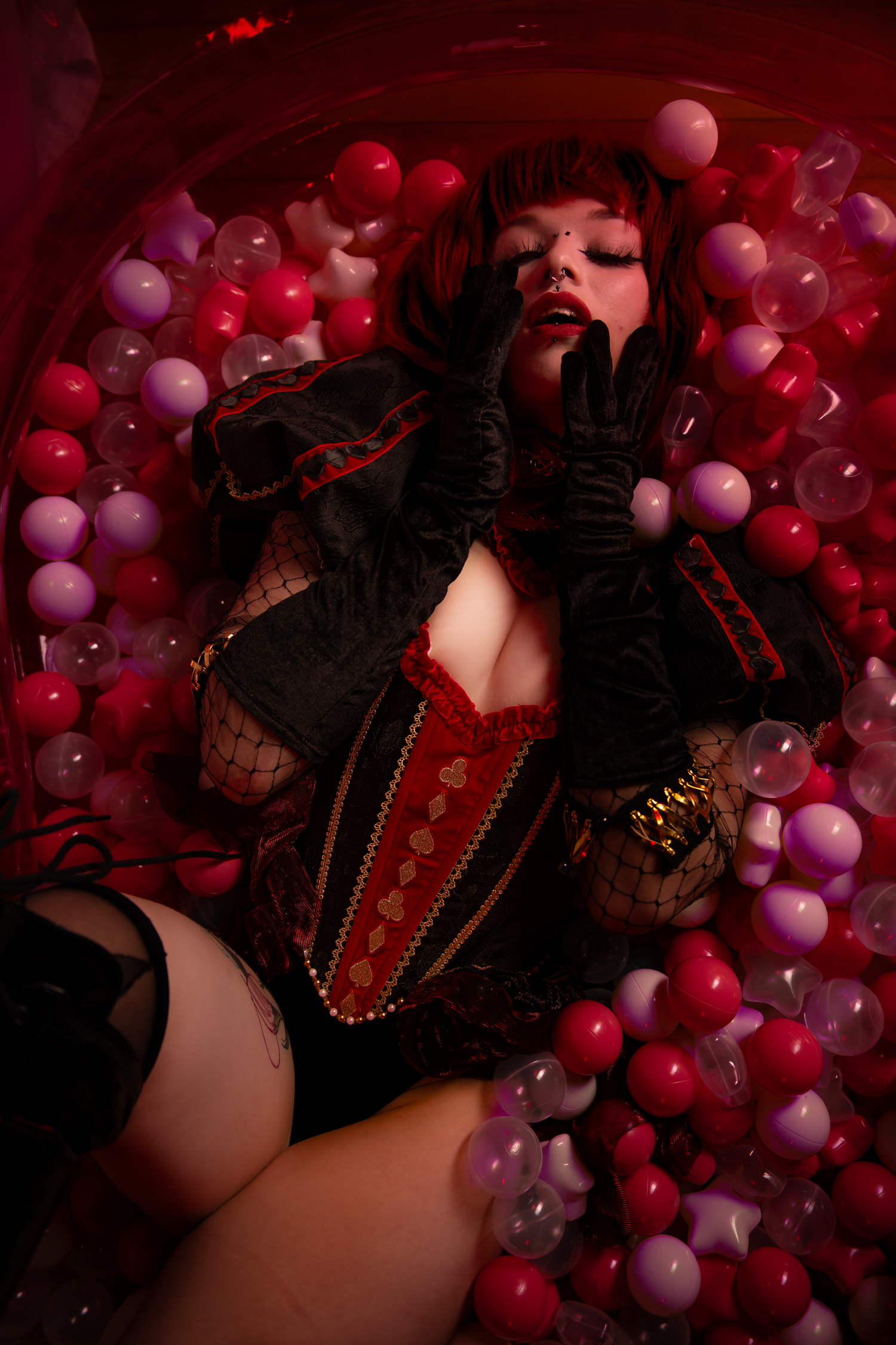 Dark and dramatic cosplay scene with red and purple balloons creating a dreamy aesthetic.