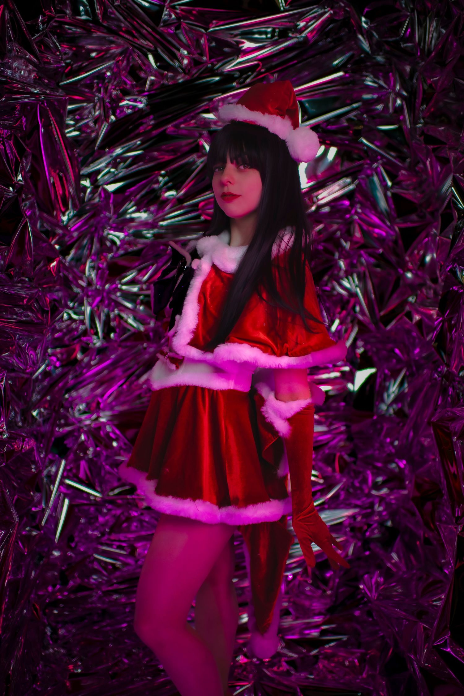 Holiday-themed photo series featuring poses against a vibrant purple metallic background.