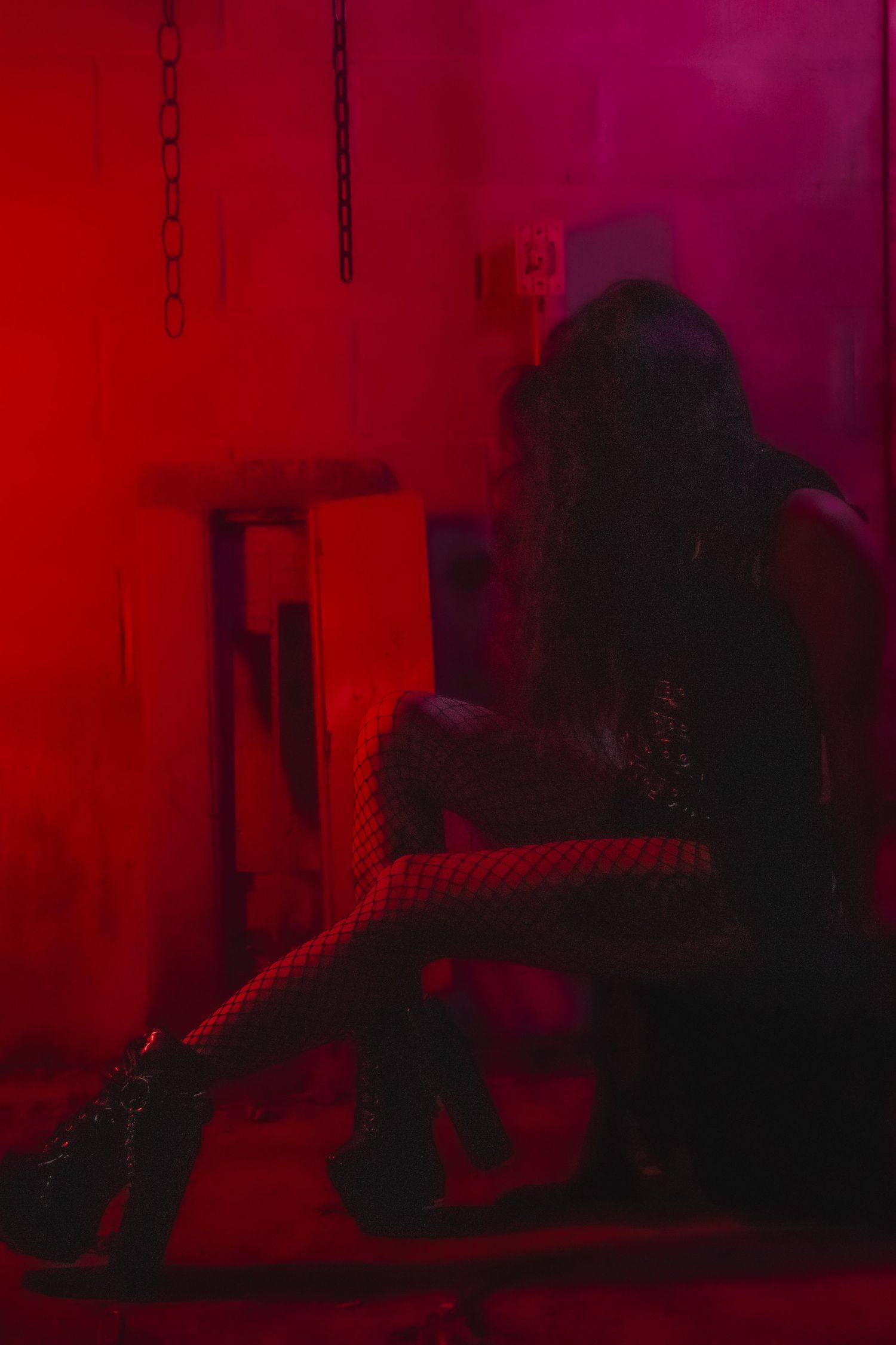 Blurry dark red atmospheric photo sequence showing silhouettes moving and disappearing into shadows.