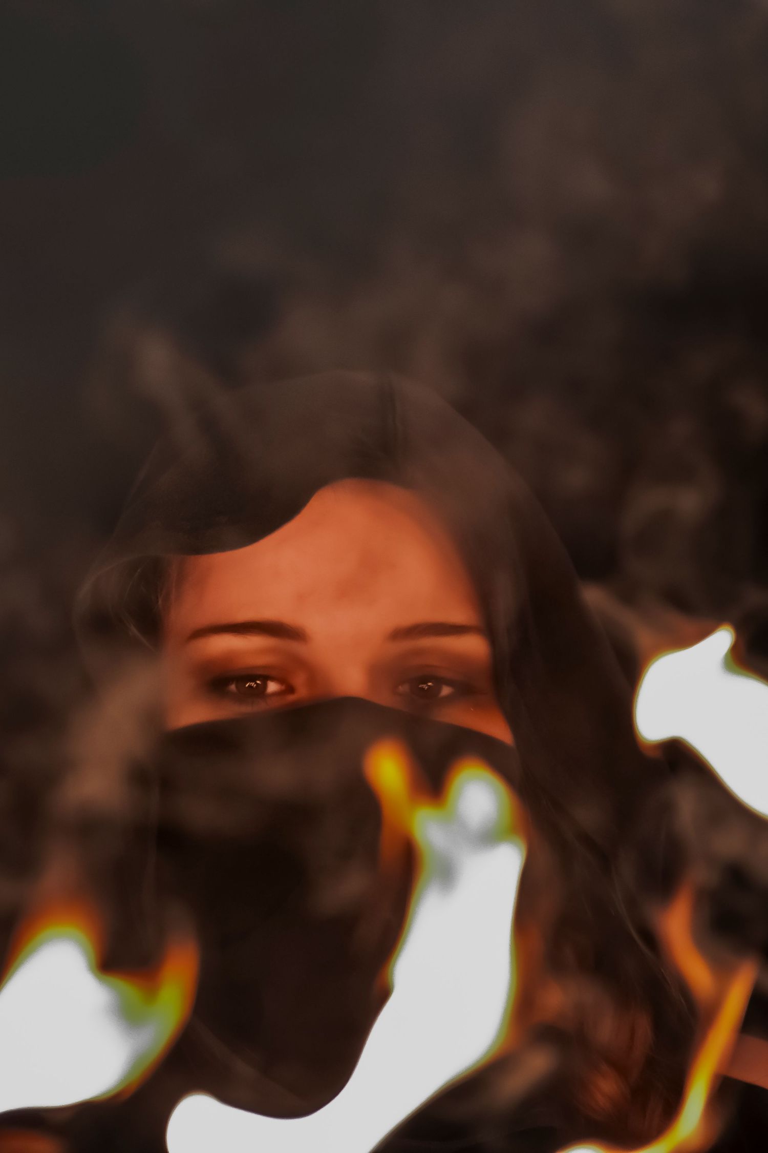 A dramatic artistic portrait sequence showing eyes emerging through dark shadows with glowing warm light effects.