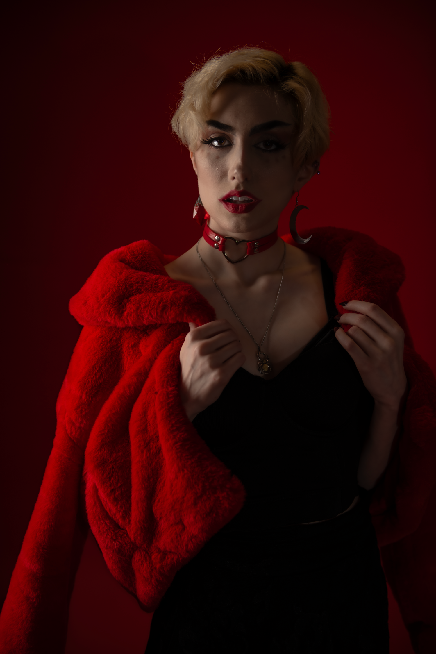 Artistic portrait series against dark red background featuring contrast between black dress and bright red fur stole.