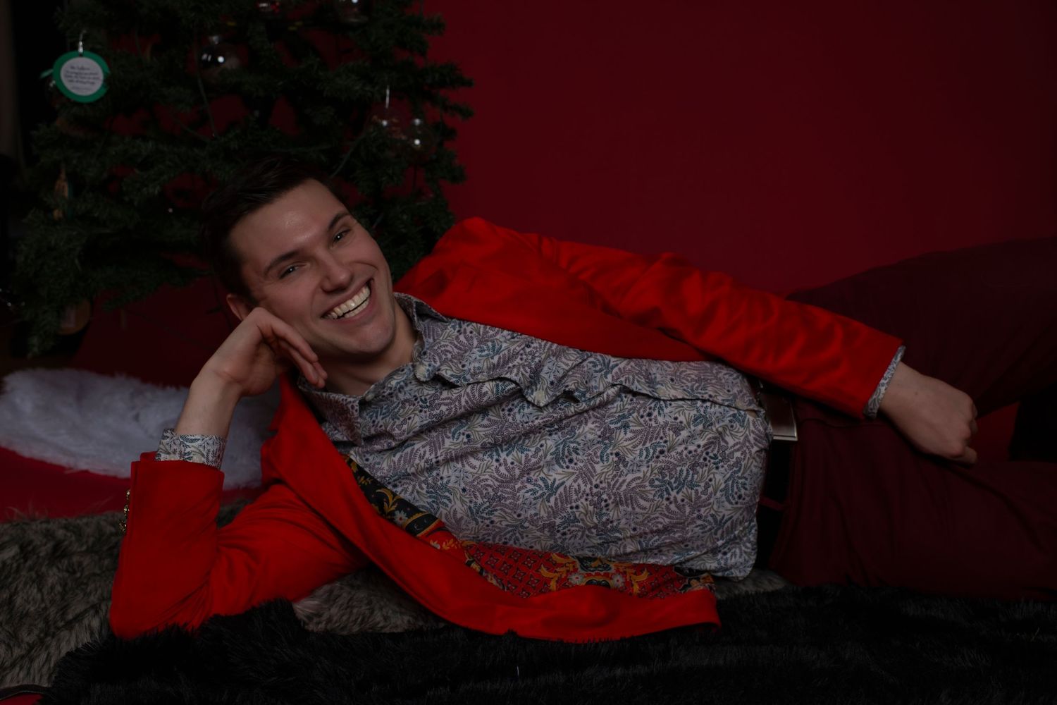 A sequence of shots shows someone in a red hoodie laying down and resting comfortably on a couch.
