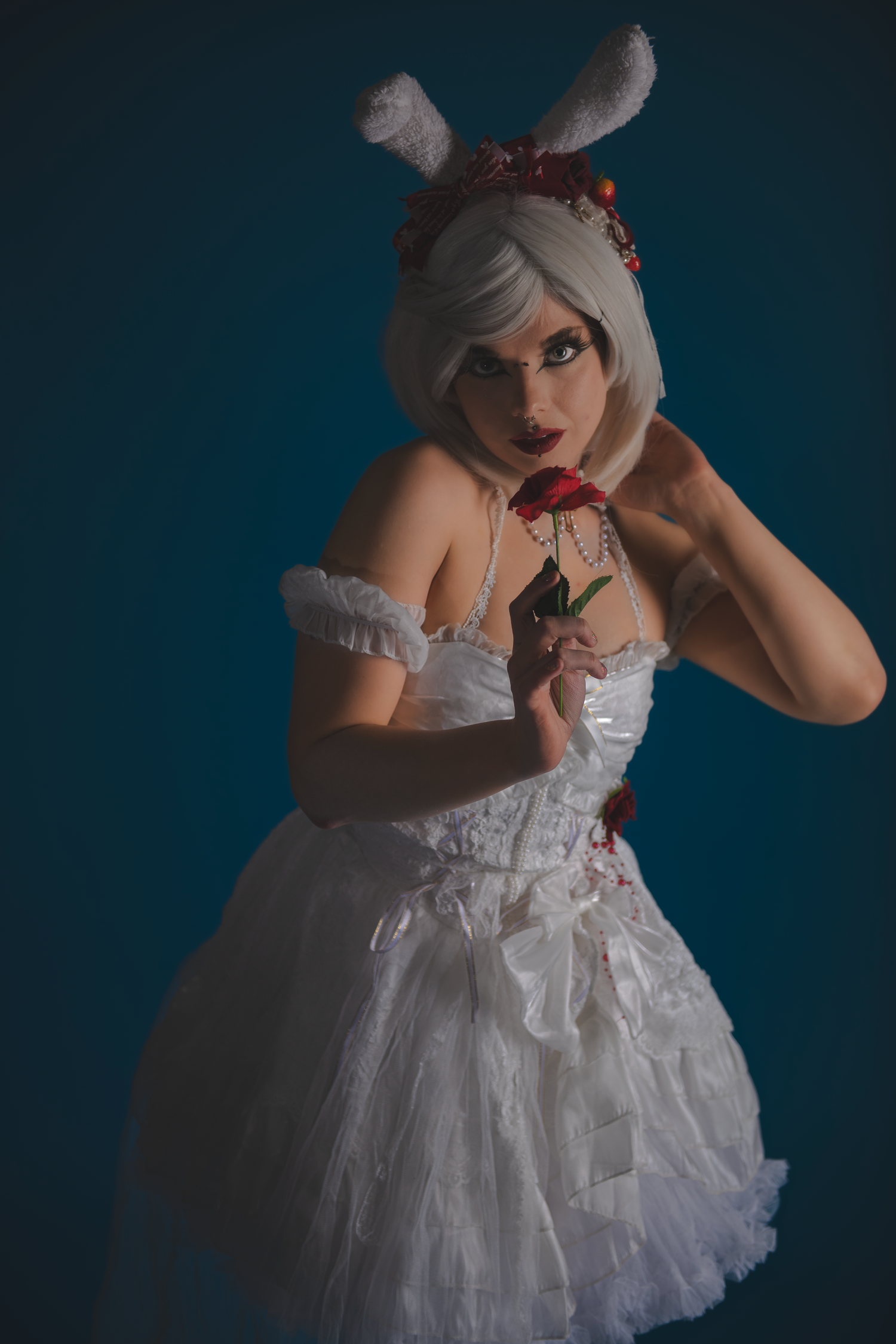 Artistic portrait series in white dress with dark atmospheric lighting.
