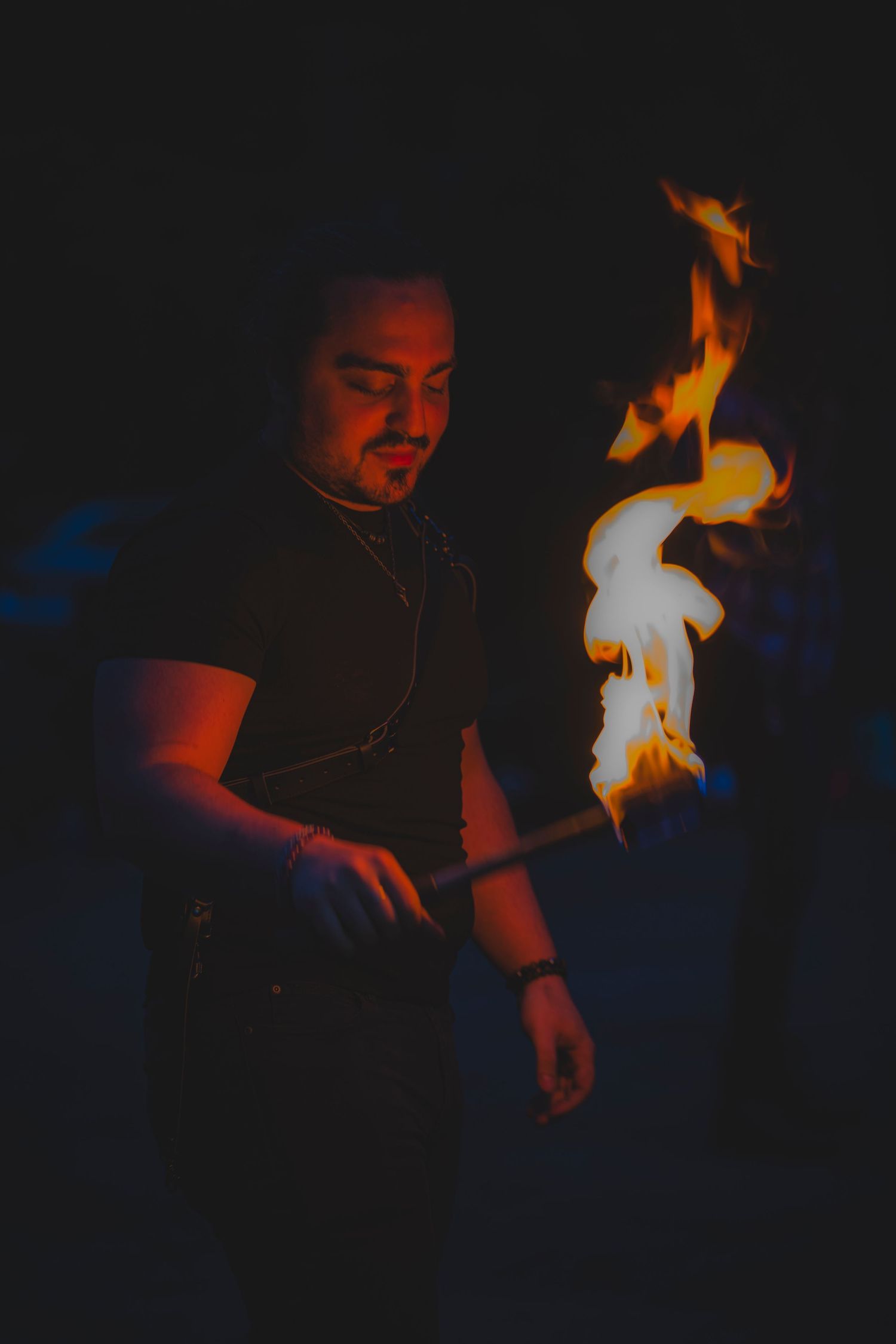 A bright torch flame illuminates a nighttime scene with dramatic shadows and orange glow.