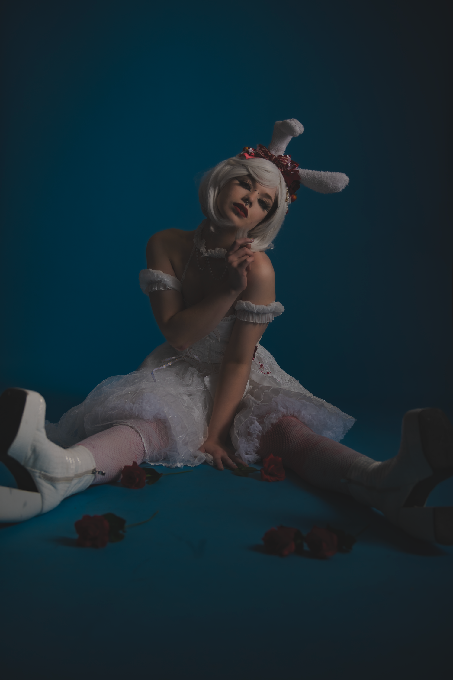 Flowing white fabric creates elegant shapes in a moody blue-tinted studio photoshoot sequence.